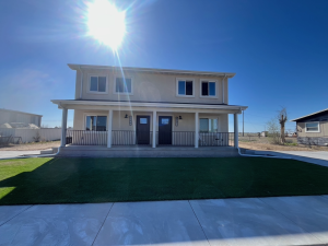 duplex building with blue sky green grass