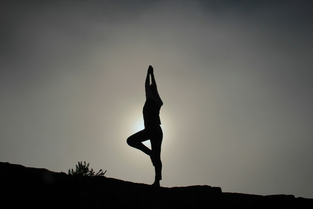 A person standing in a yoga position.