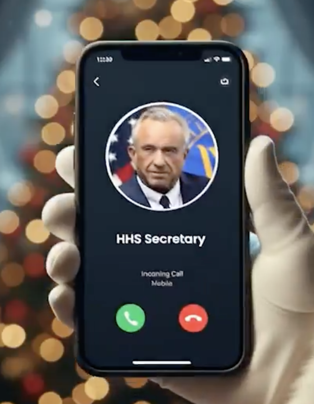 Hand holding a smartphone displaying an incoming call from the HHS Secretary, with a blurred festive background of Christmas lights.
