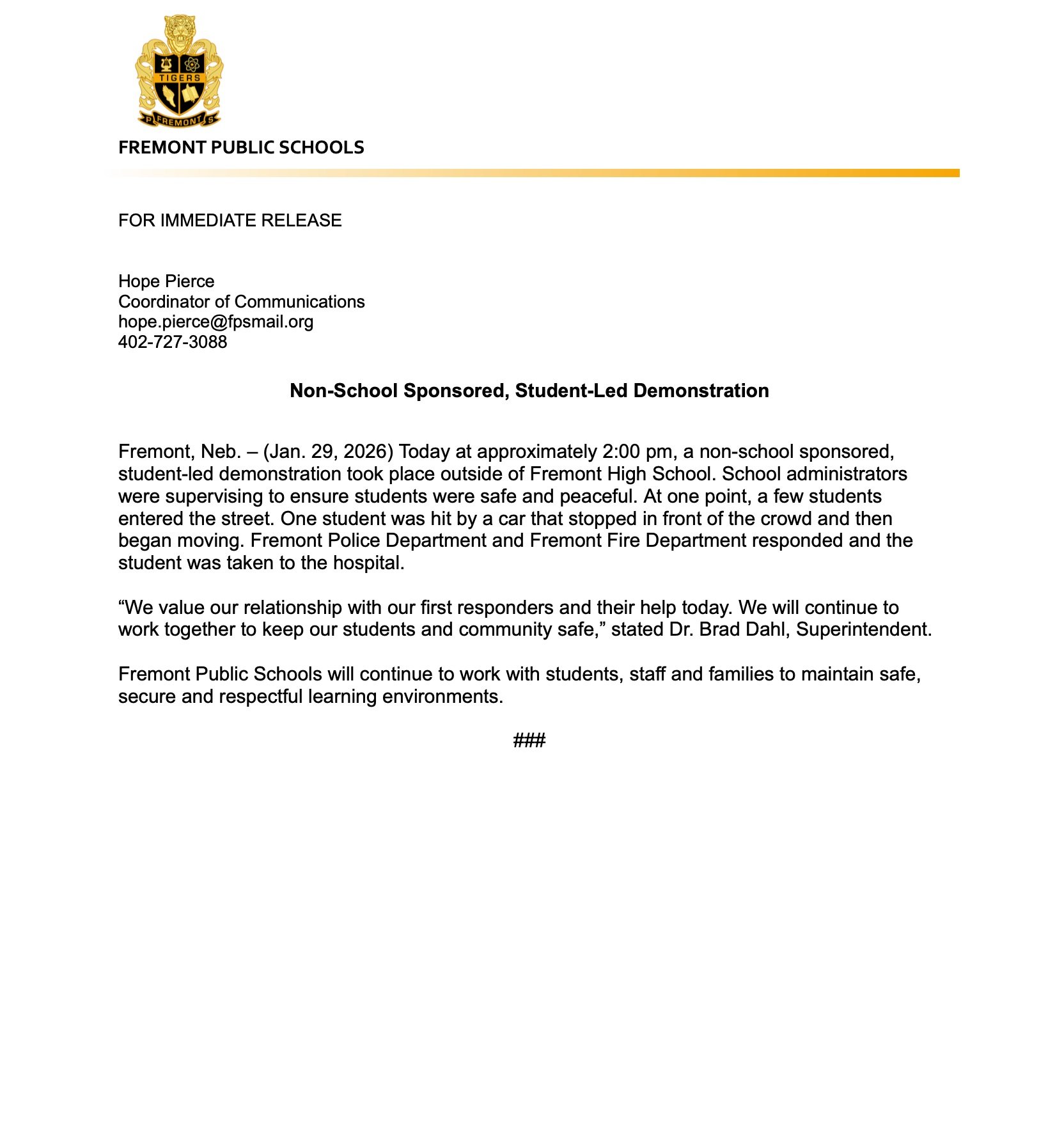 Fremont High School administrators oversee a student-led demonstration, ensuring safety as a student is treated after being struck by a car during the event.