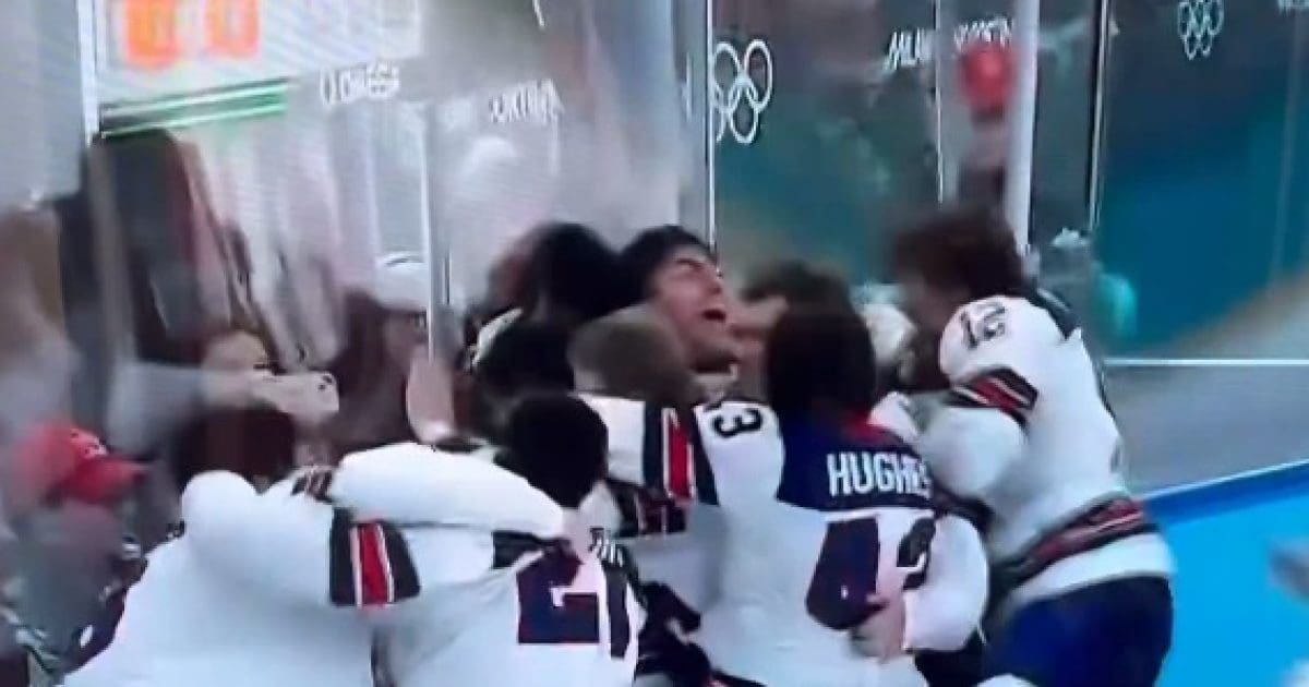 Celebrating athletes embrace in excitement after a significant victory during the Olympics, showcasing teamwork and jubilation.