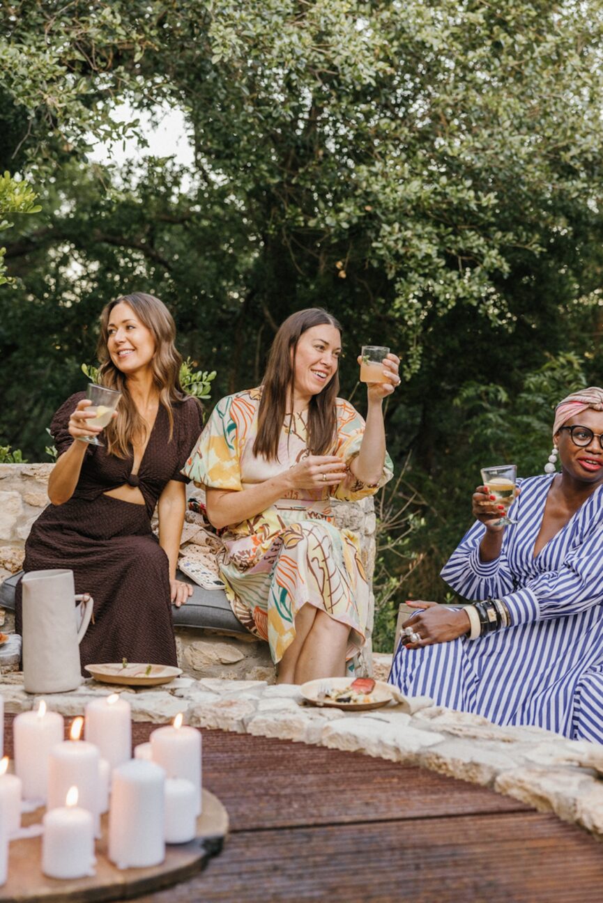 Women friends drinking wine outside.