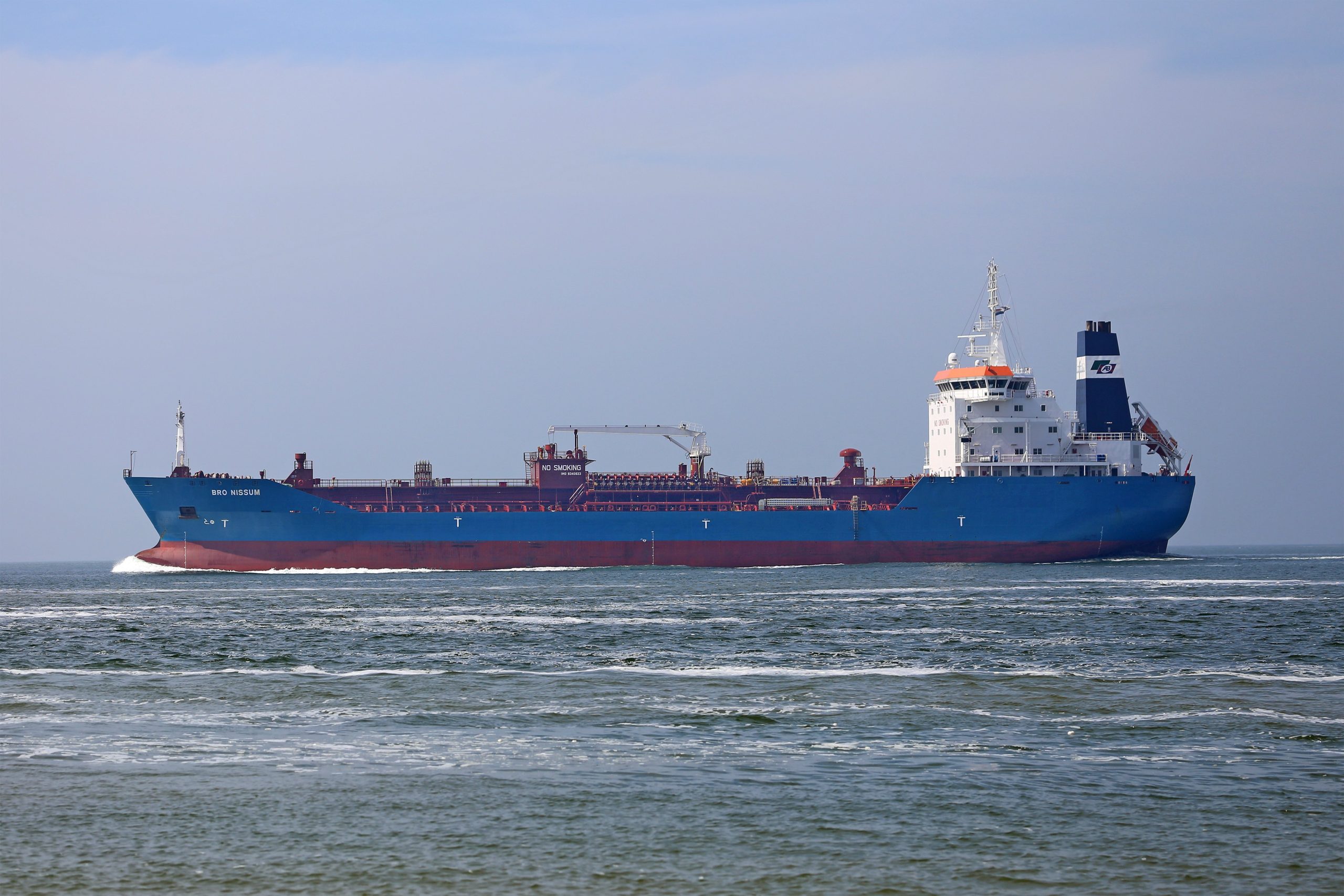 Large cargo ship named Bro Nilsum navigating through calm waters under a clear sky, showcasing maritime transport and shipping industry.
