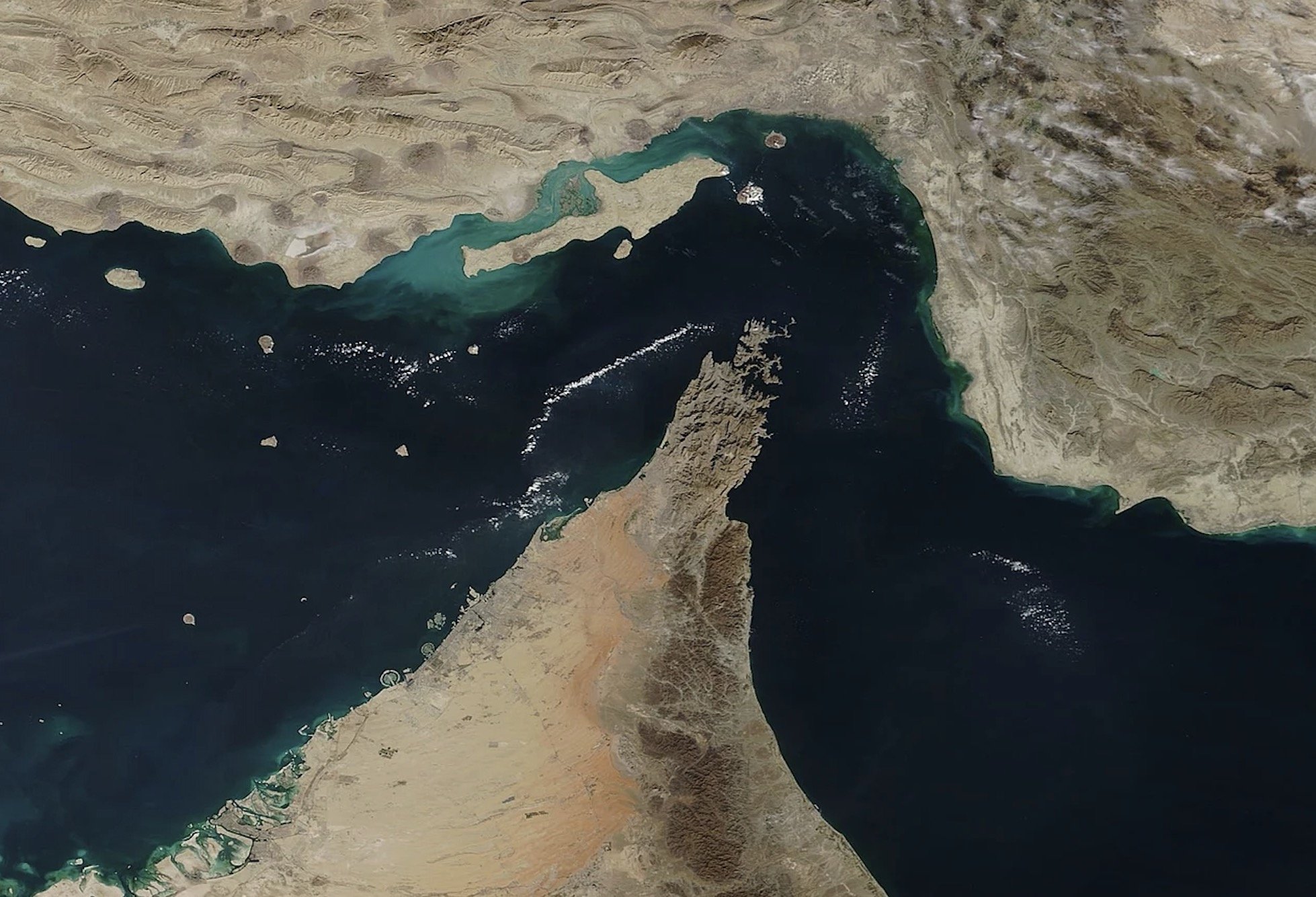 Aerial view of the Straits of Hormuz, showcasing the coastline and surrounding islands, highlighting the geographical features of the region.