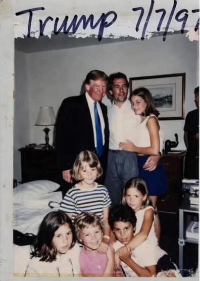 Donald Trump poses with a group of children and an adult male in a hotel room, captured in a photo dated July 7, 1997.