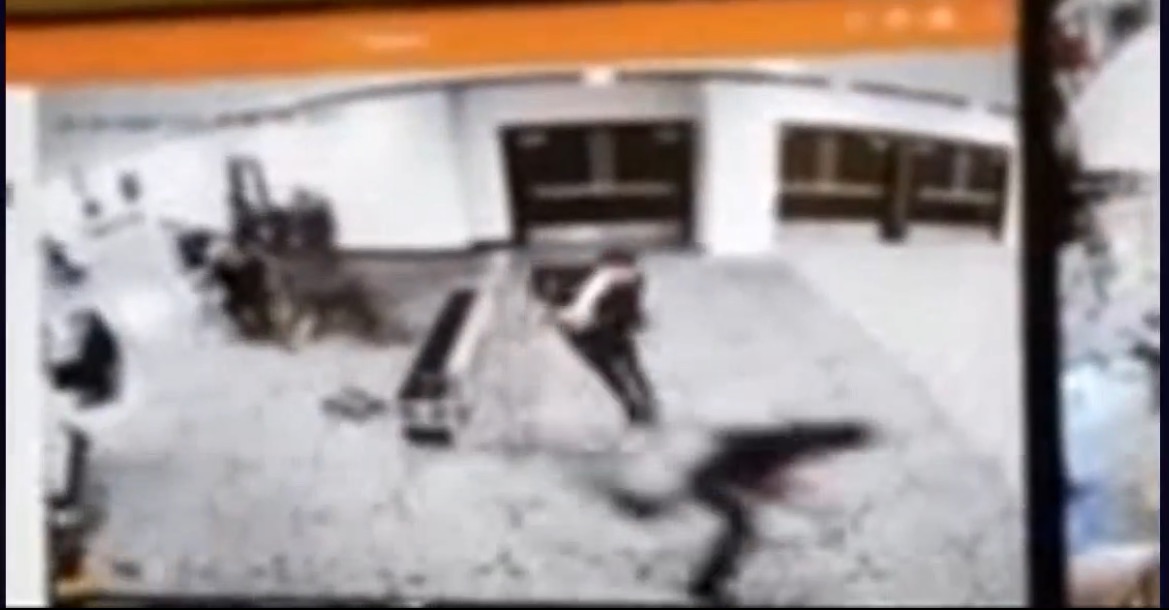 Surveillance footage captures a person moving through a public space, highlighting activity in a busy environment.