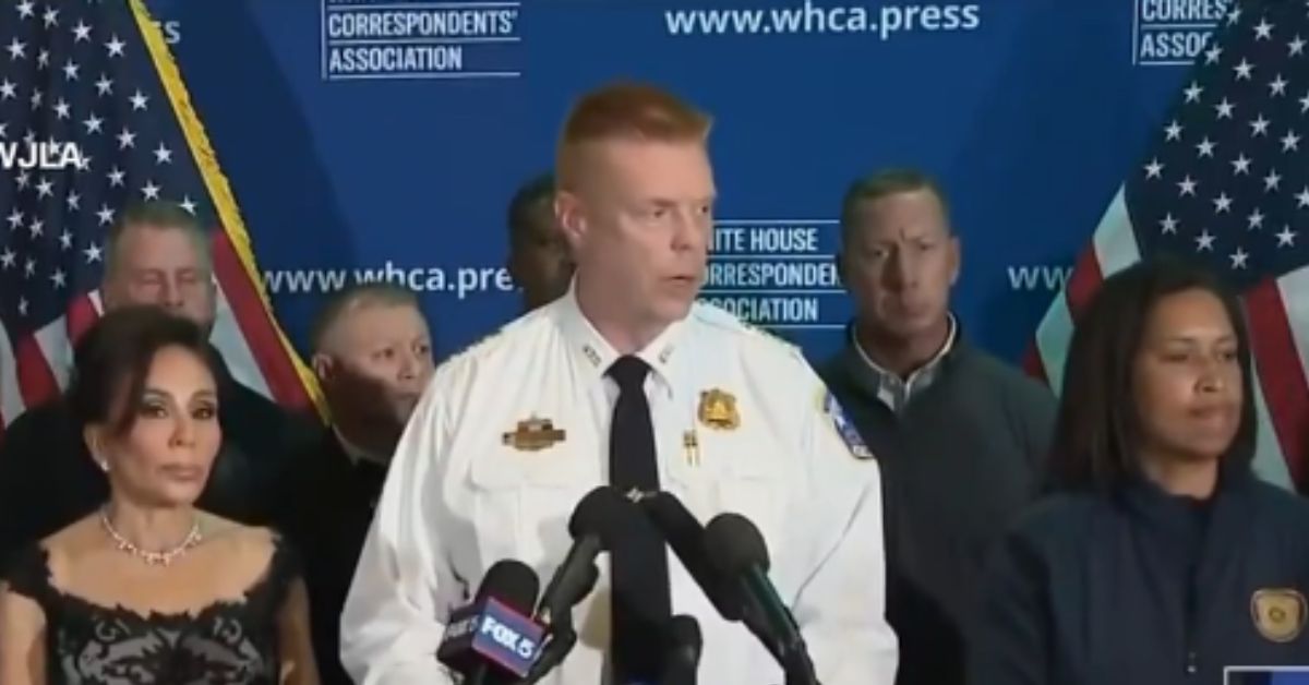 Press conference featuring law enforcement officials addressing the media, with American flags in the background, discussing public safety issues and community relations.