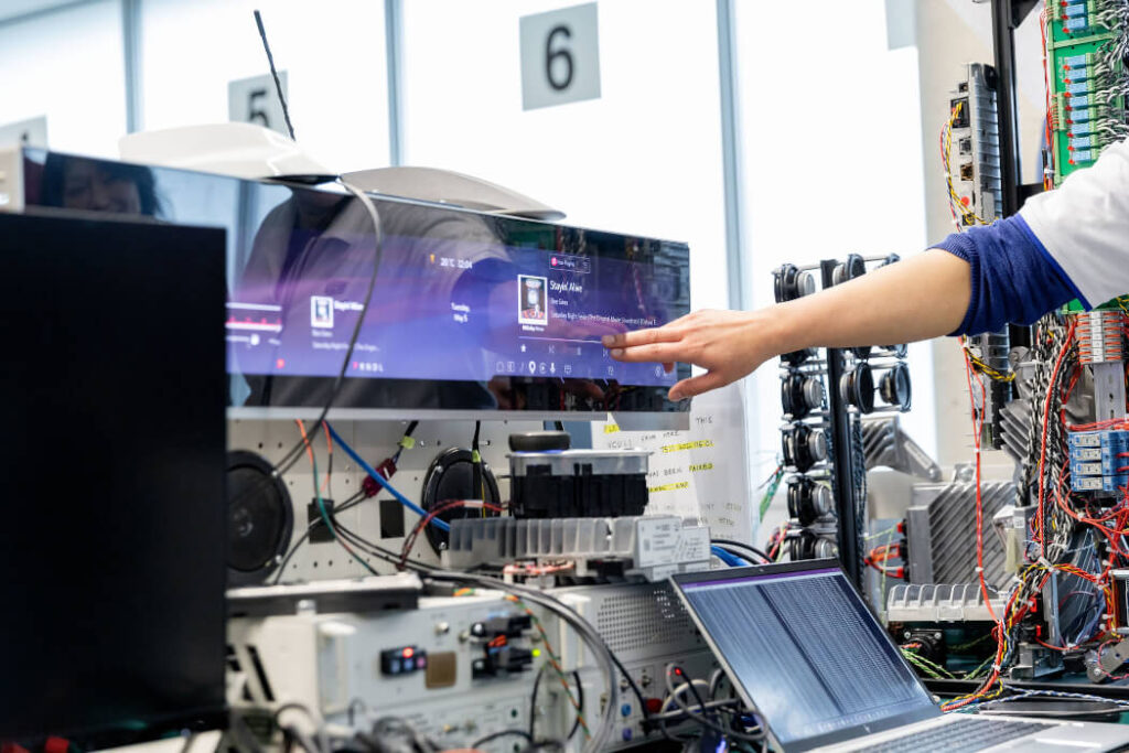 A hand points at a computer screen