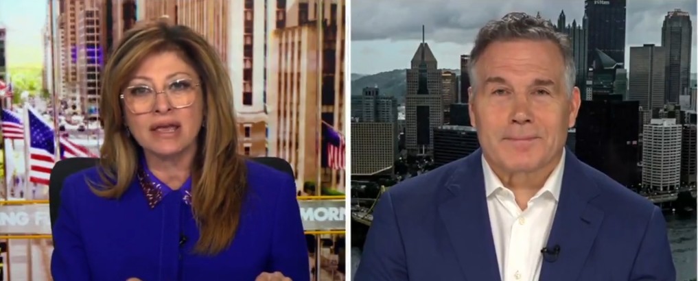 News anchors discussing current events with a city skyline in the background, highlighting business and financial topics.