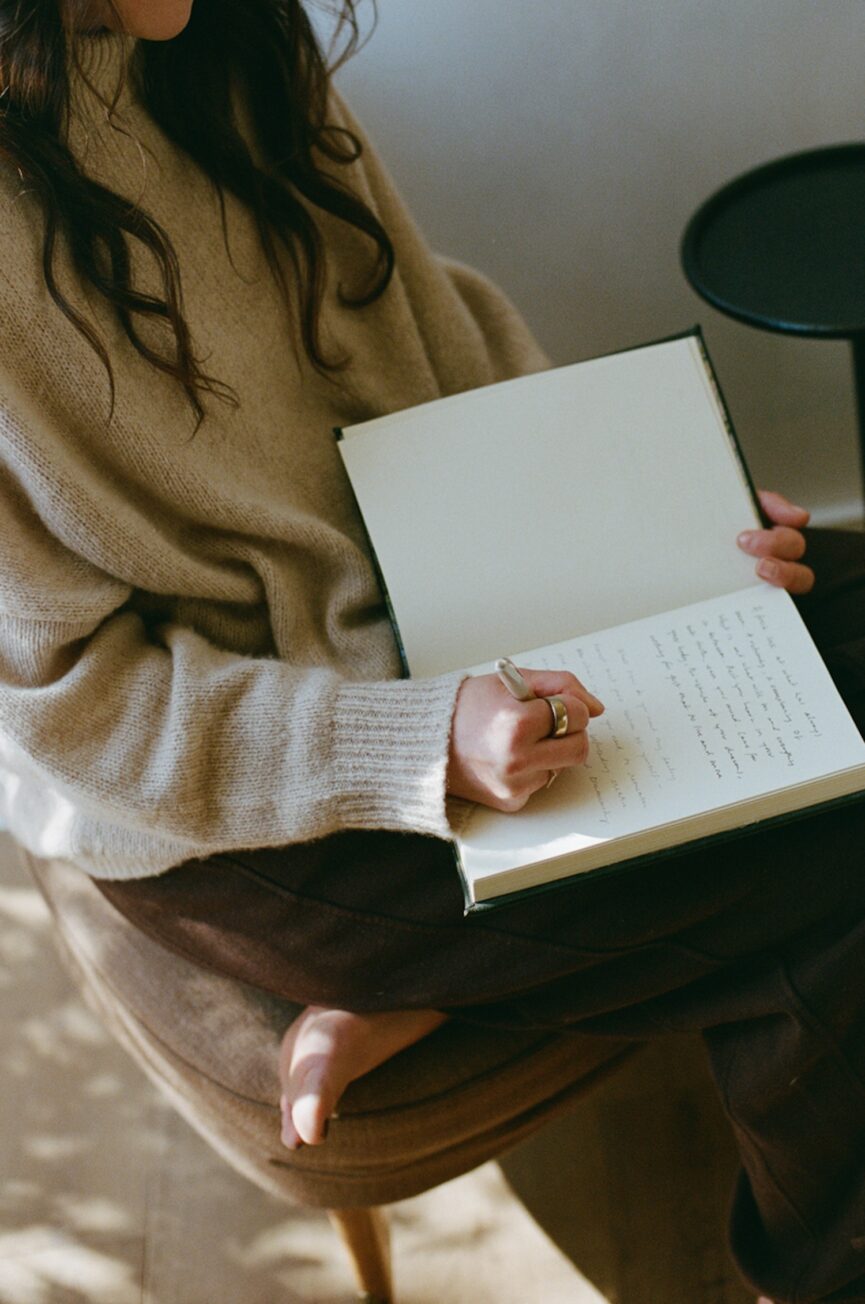 Woman journaling about health benefits of sex.