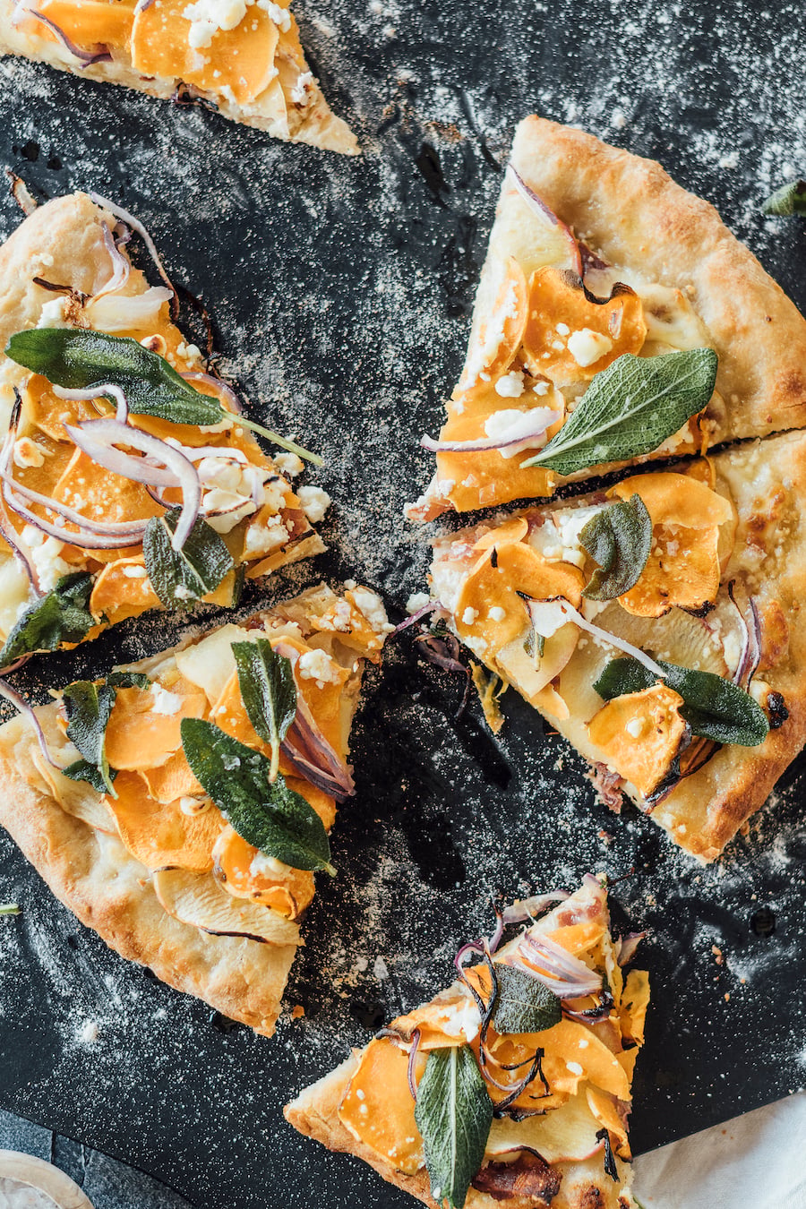 homemade fall pizza with sweet potatoes, apple, bacon and fried sage