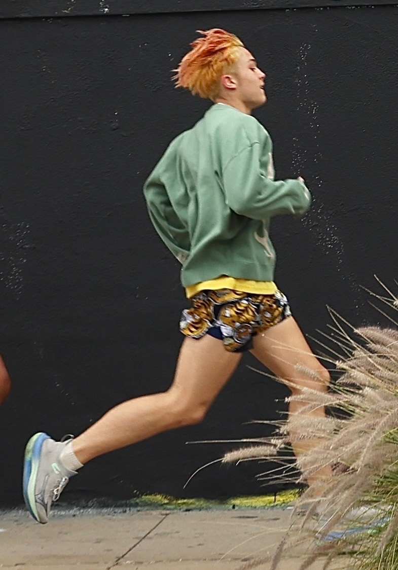 Knox Jolie-Pitt sprinting through the streets of Los Angeles during an outdoor workout session with a trainer