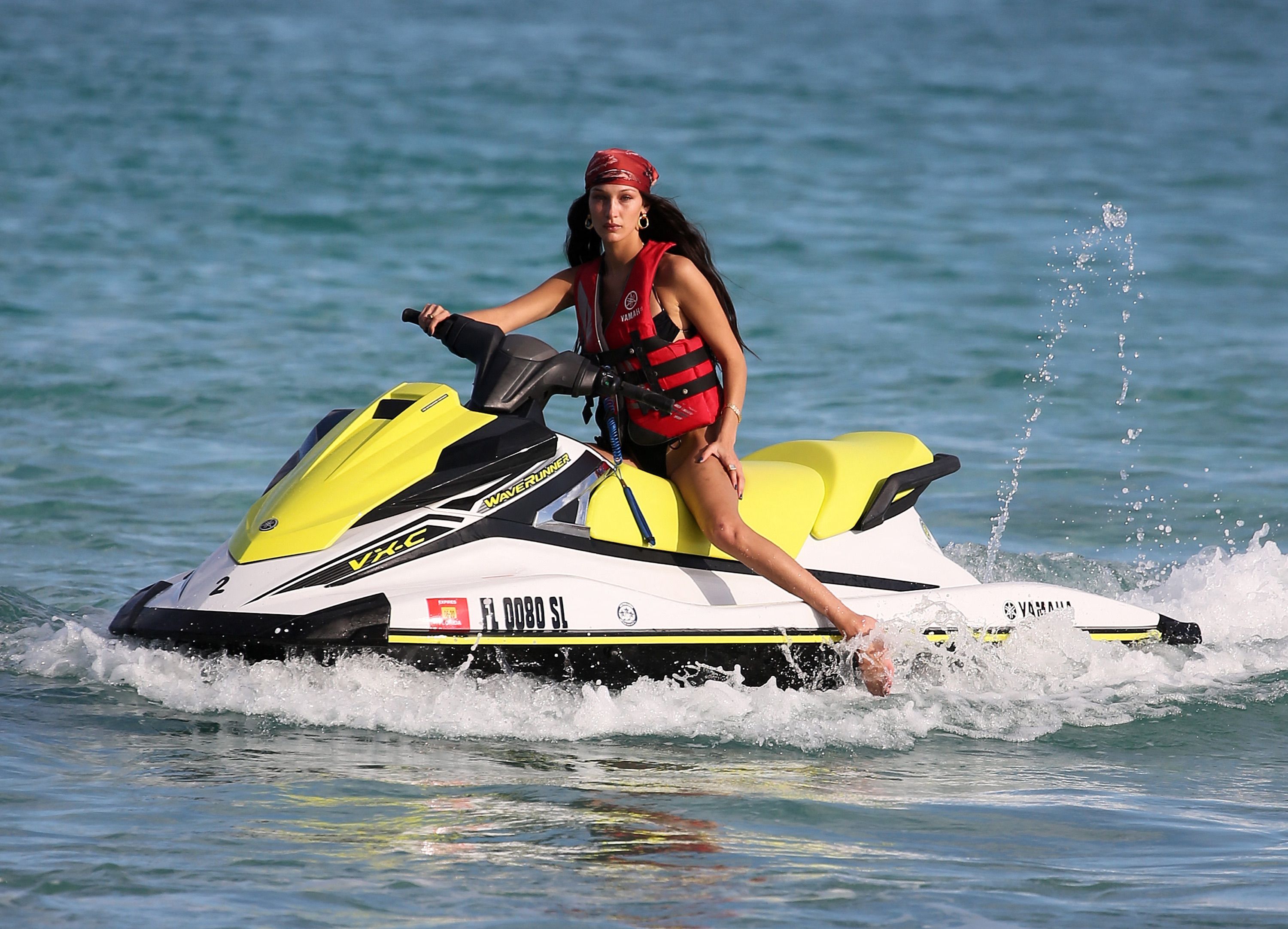 Bella Hadid and Kendall Jenner in bikinis riding jet skis on the water in Miami