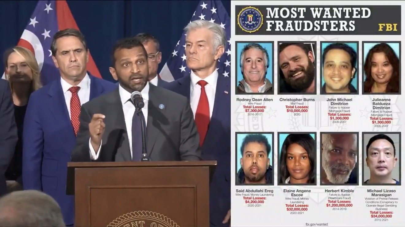 FBI press conference featuring officials discussing the Most Wanted Fraudsters list, showcasing images and details of individuals involved in significant financial crimes.
