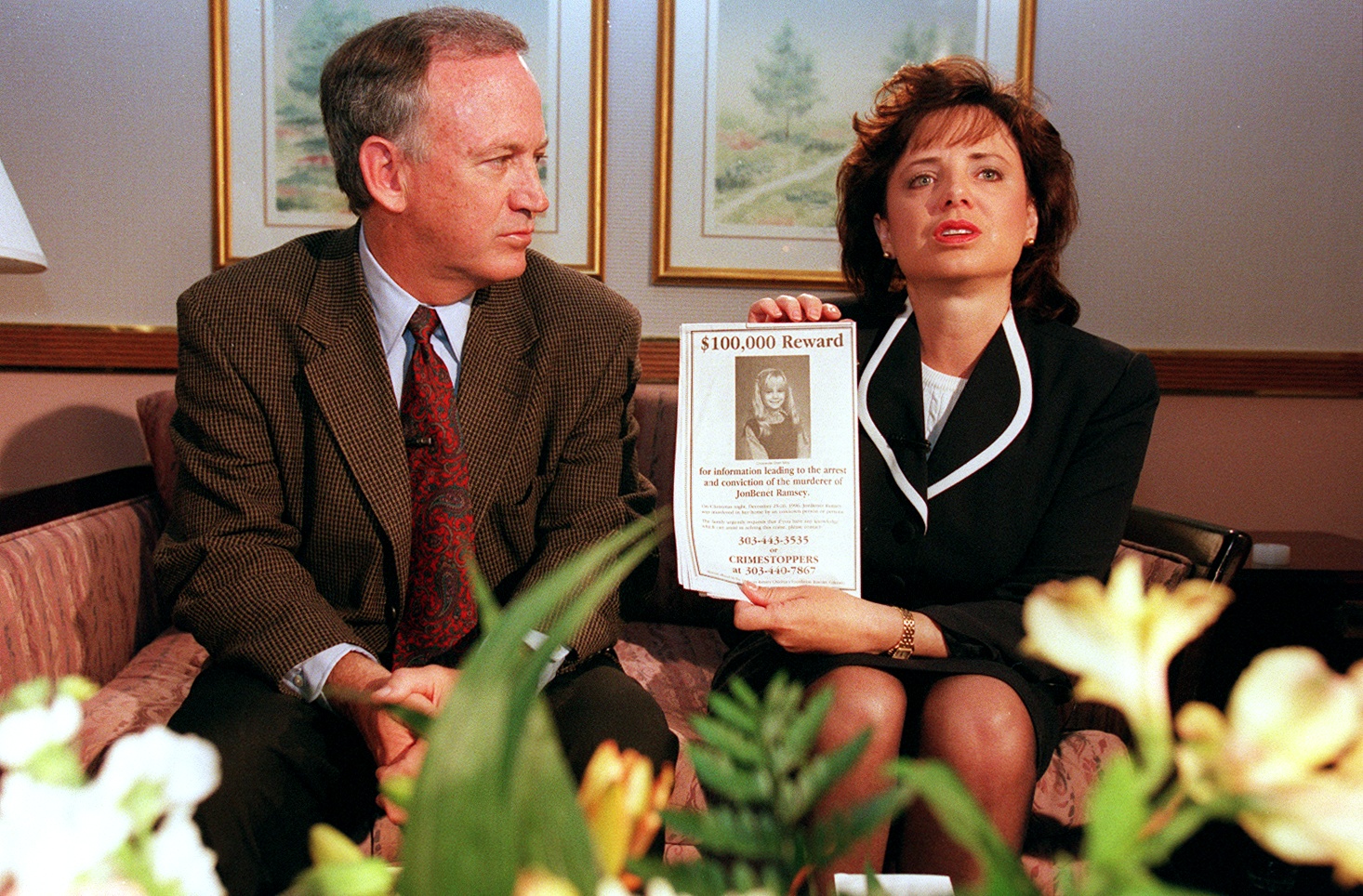 John and Patsy Ramsey speaking to media, with Patsy holding a reward sign for information on JonBenét Ramsey's murderer
