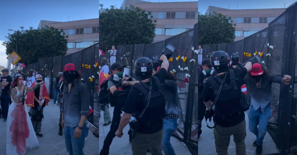 Protesters clash near a barricade, with individuals in costumes and masks, highlighting tensions during a public demonstration.