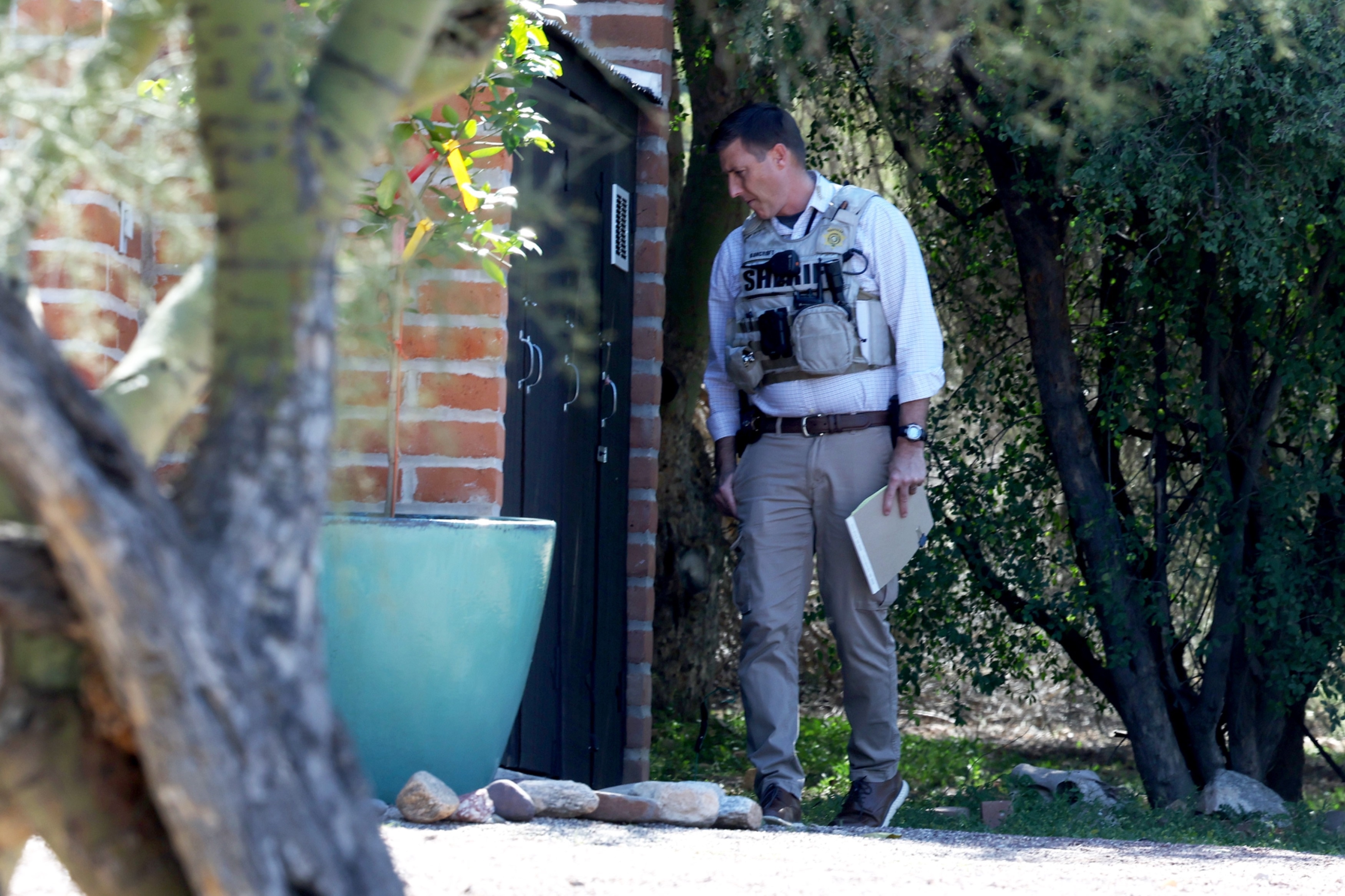 Sheriff's deputies leaving Nancy Guthrie's house after searching the garden