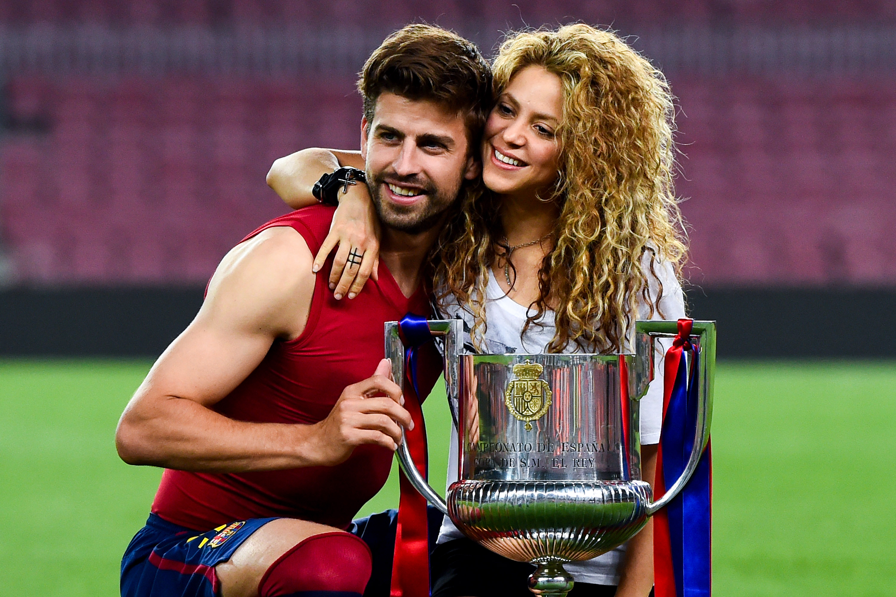 Shakira and Gerard Piqué posing together with the Copa del Rey trophy at Camp Nou in Barcelona