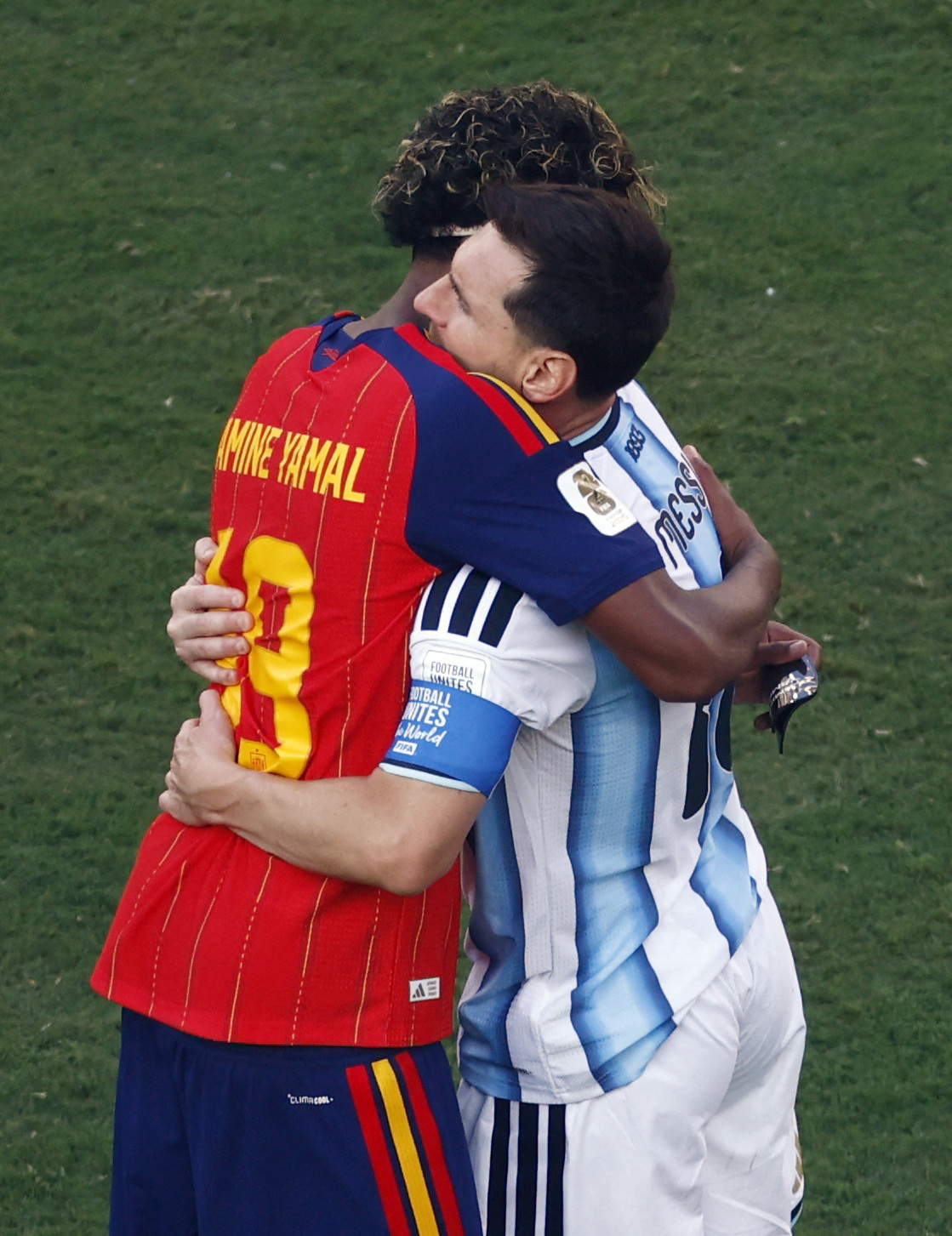 Lamine Yamal and Lionel Messi hugging on the soccer field after the 2026 FIFA World Cup Final