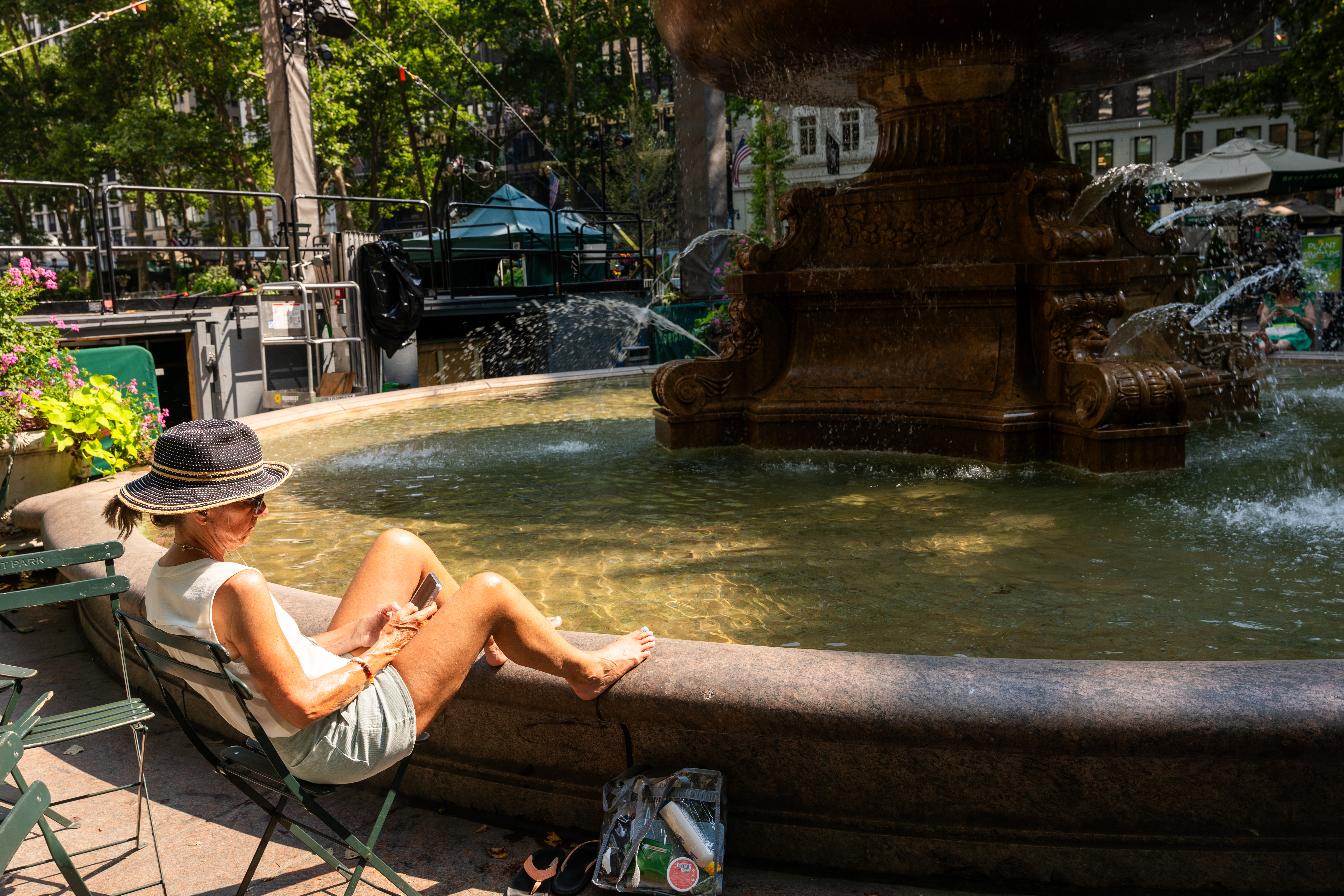 People cooling off in Bryant Park in Manhattan during a heat wave in New York City