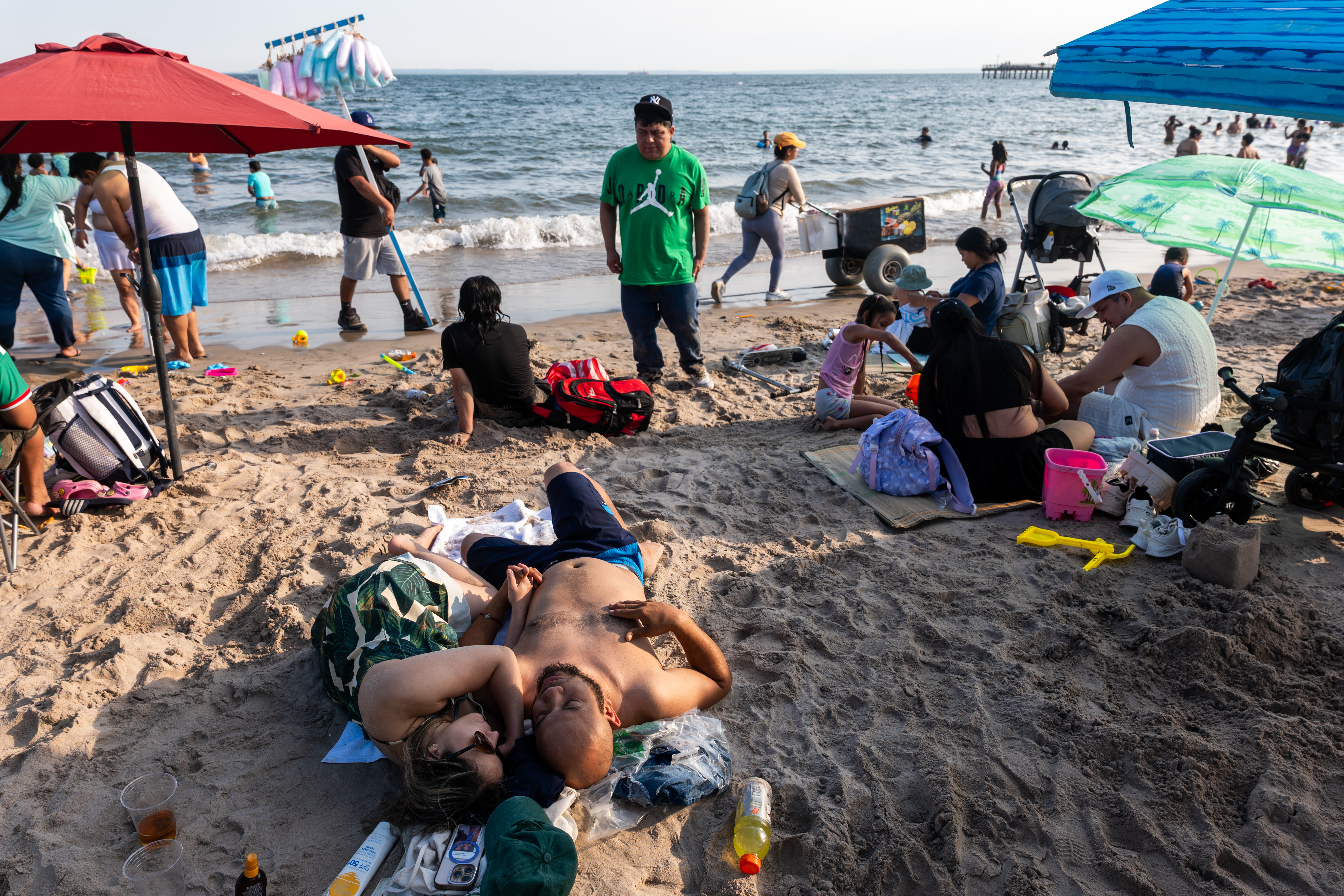 Crowds of people cooling off at Coney Island beach in Brooklyn during a heat wave