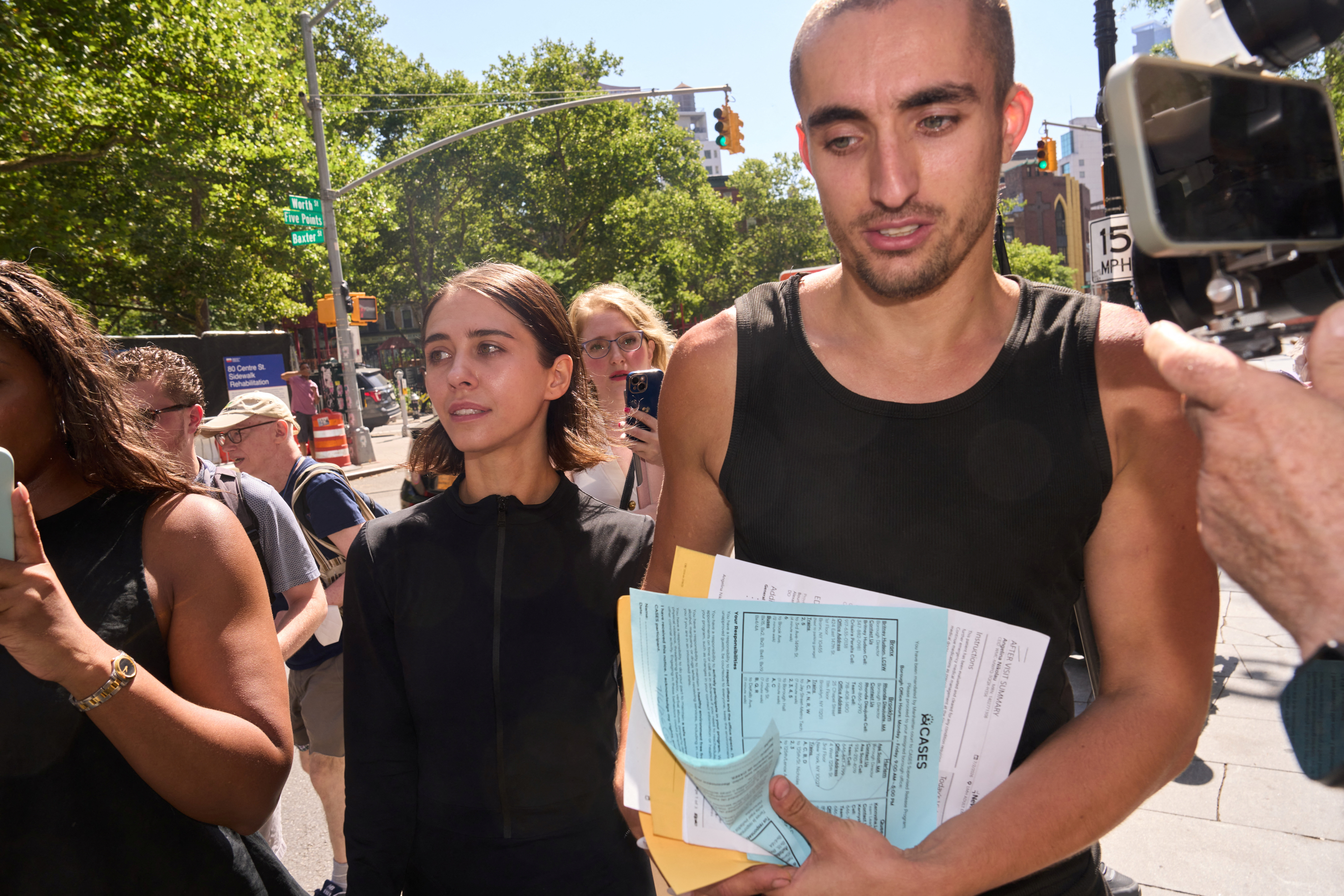 Angela Nikolau and Ivan Beerkus walking out of New York City Criminal Court after their arraignment