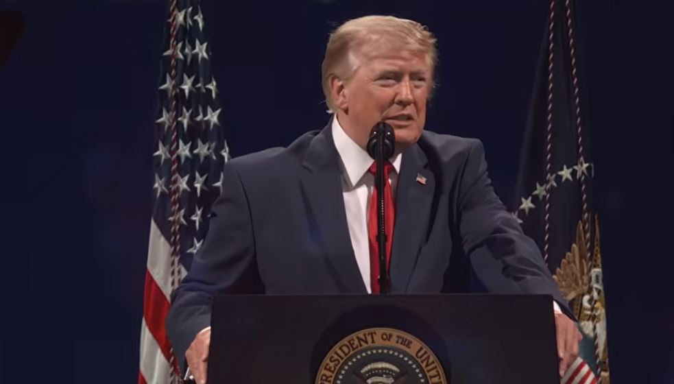Donald Trump delivering a speech at a podium with the Presidential seal, flanked by American flags.
