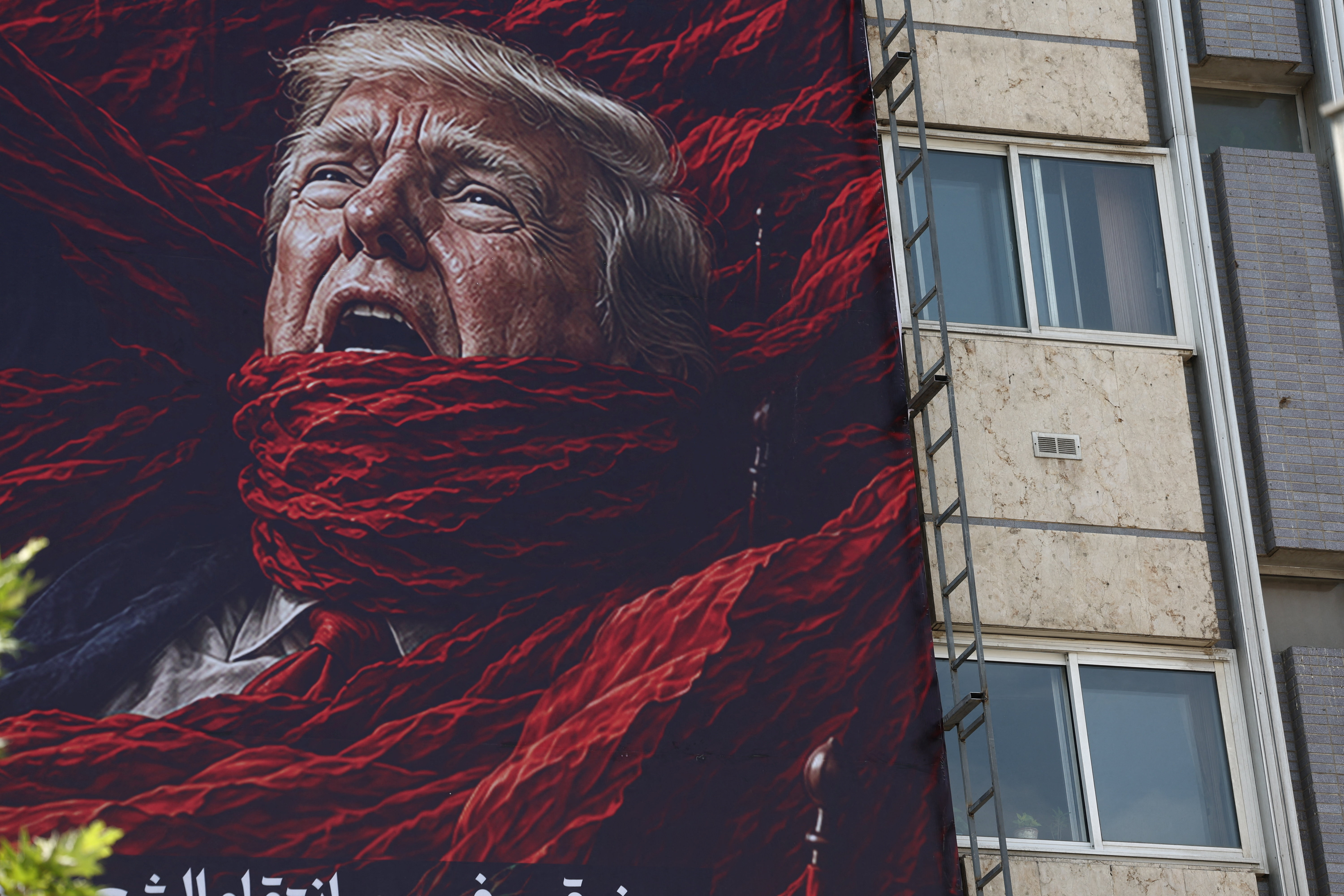 A large billboard depicting U.S. President Donald Trump mounted on a building in Tehran, Iran.
