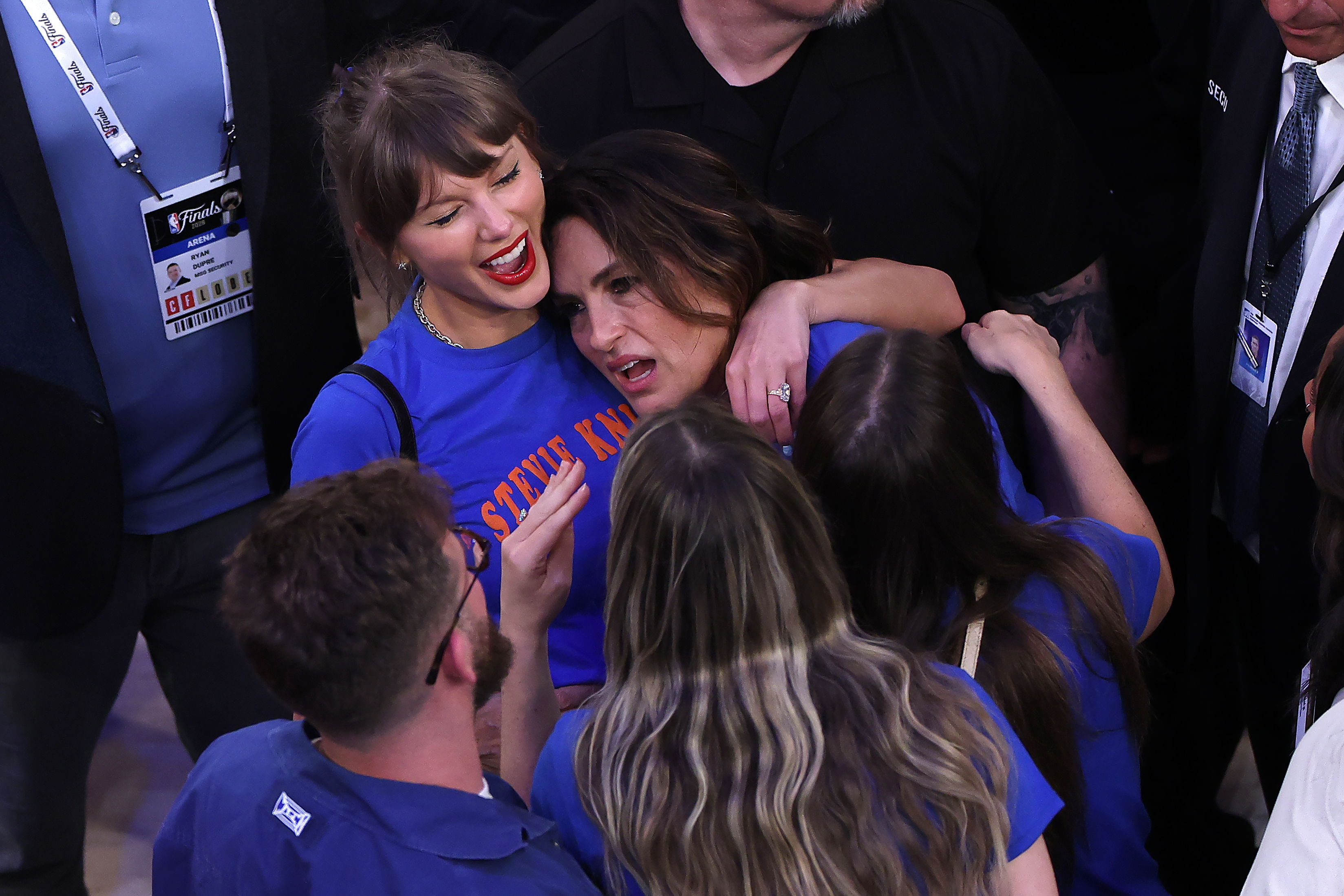 Taylor Swift and Mariska Hargitay sitting together in the stands at Madison Square Garden during the 2026 NBA Finals