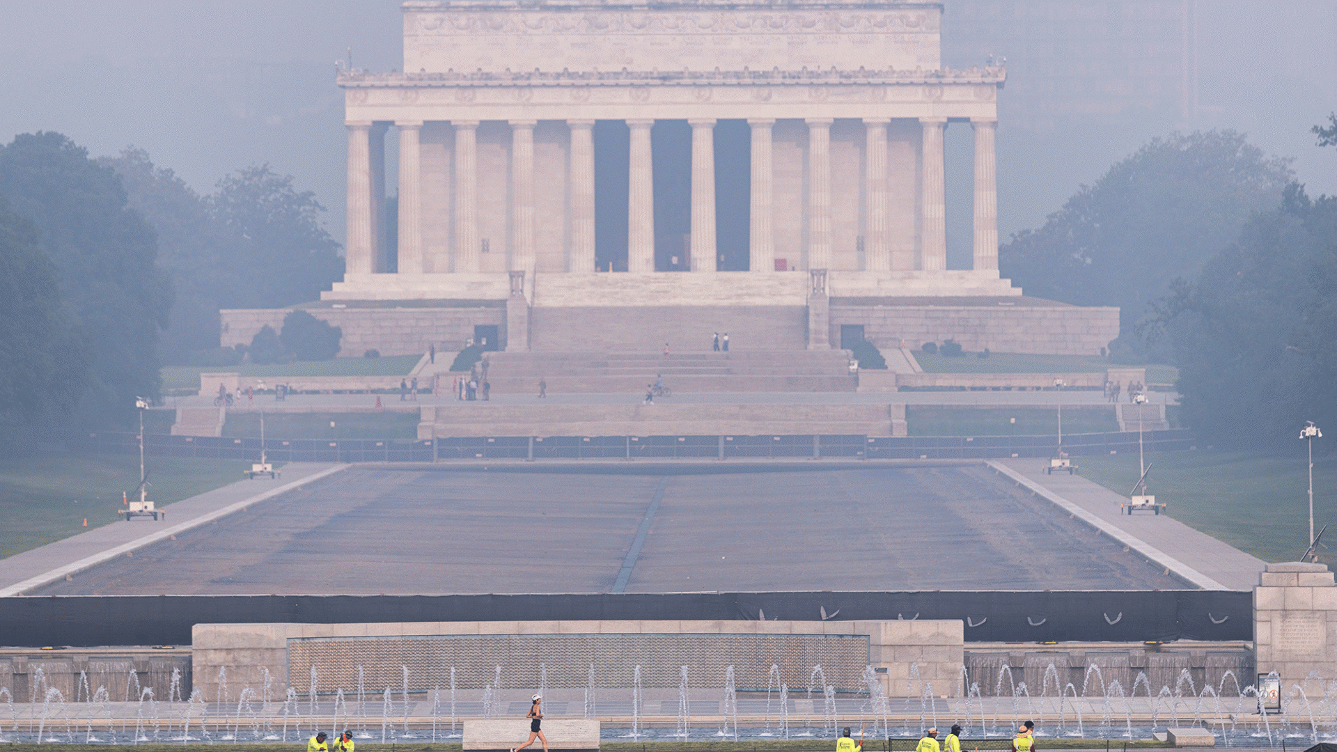 A smoky view of the Lincoln memorial, a large pillared building.
