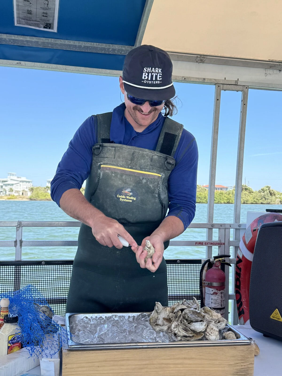Sam Walsh, owner of Sharkbite Oysters in New Smyrna Beach, Florida, gives a demonstration of oyster shucking as part of an educational tour for the nonprofit organization Oyster South.