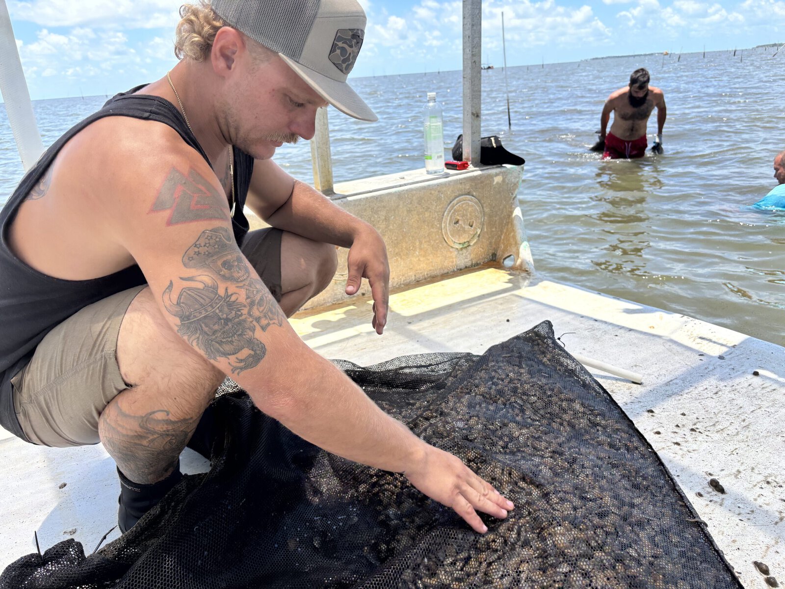 A shellfish farmer on a boat.