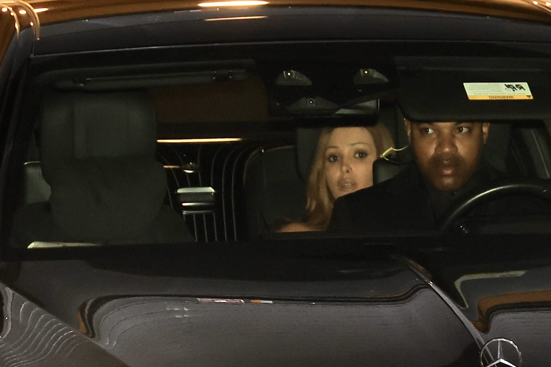 Kanye West and Bianca Censori seated together in the back of a chauffeured car at New Orleans airport