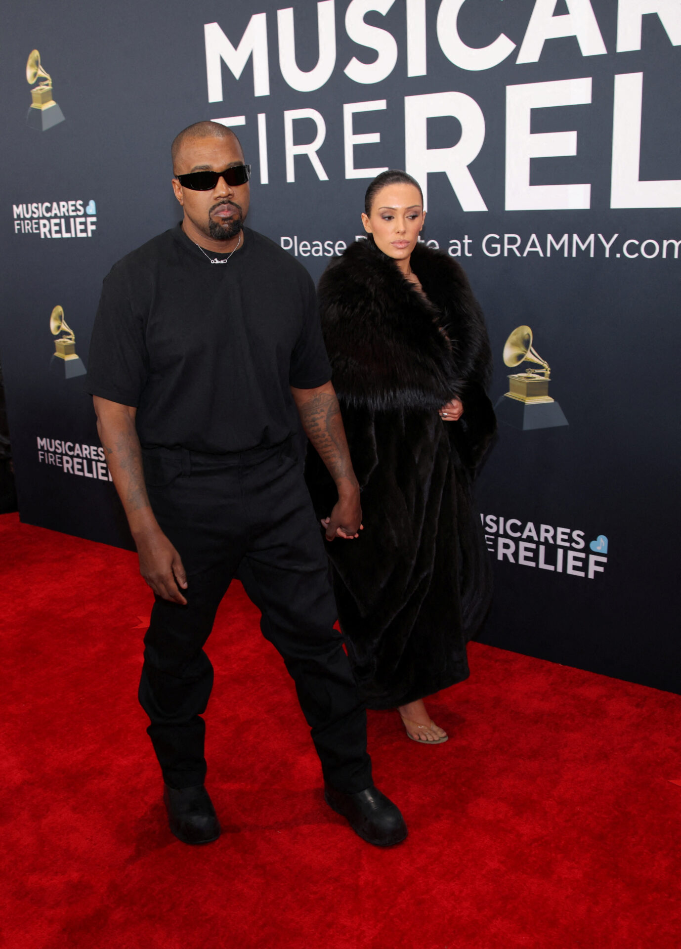 Kanye West and Bianca Censori posing together on the Grammy Awards red carpet in Los Angeles