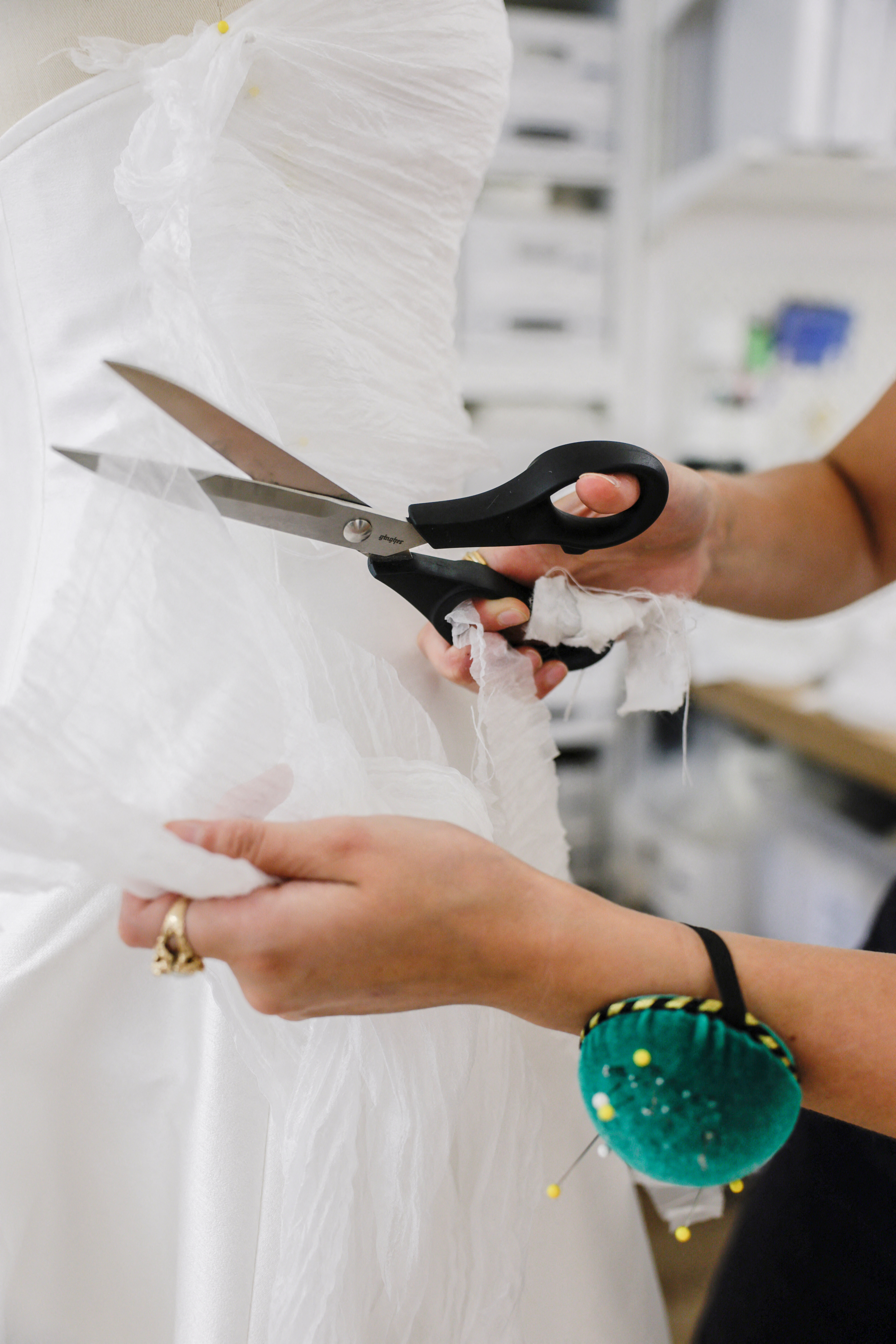 Designer Kat Eberley sewing a dress at the Jenny Yoo bridal boutique in New York City