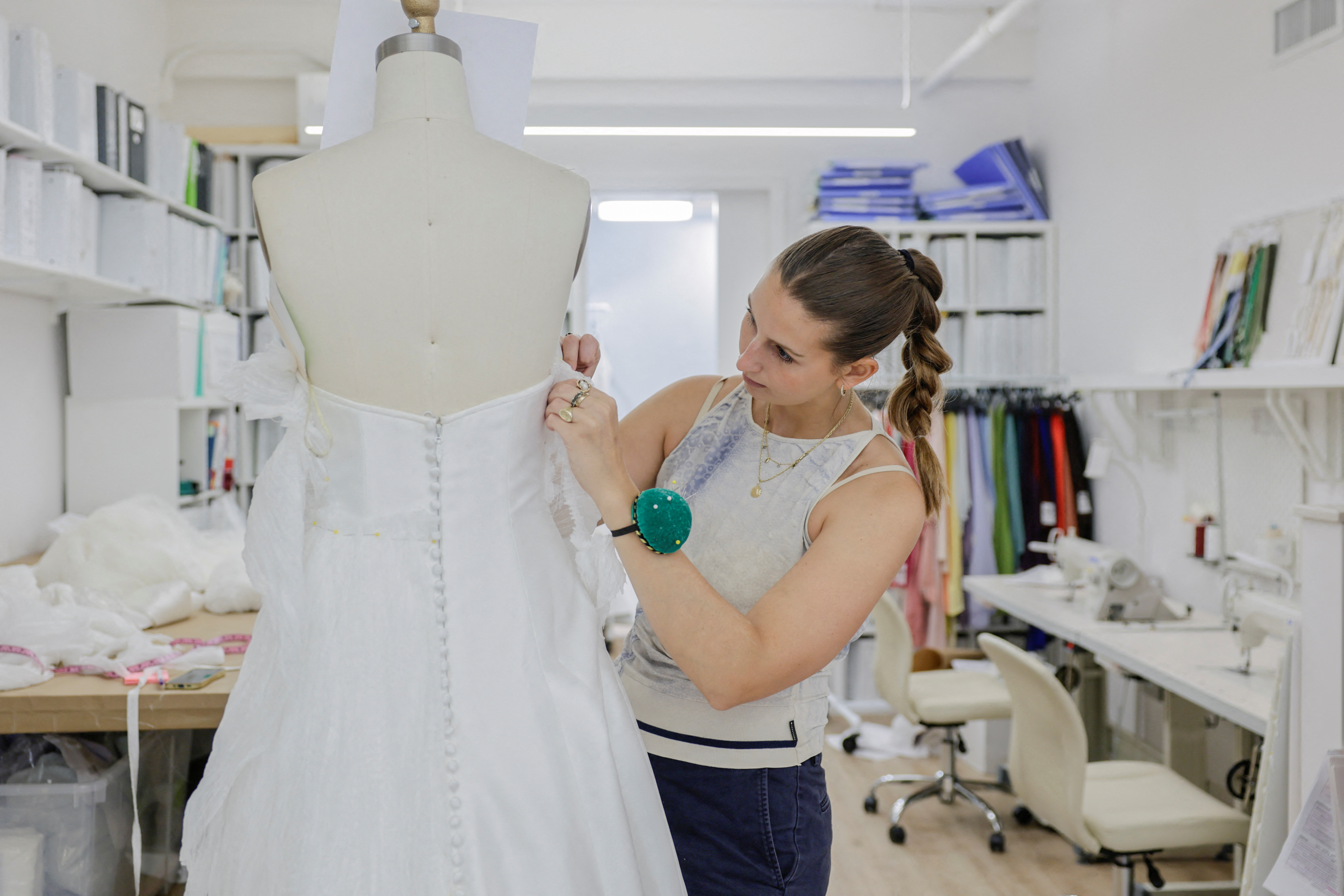 Designer Kat Eberley working on a bridal gown at the Jenny Yoo boutique in New York City