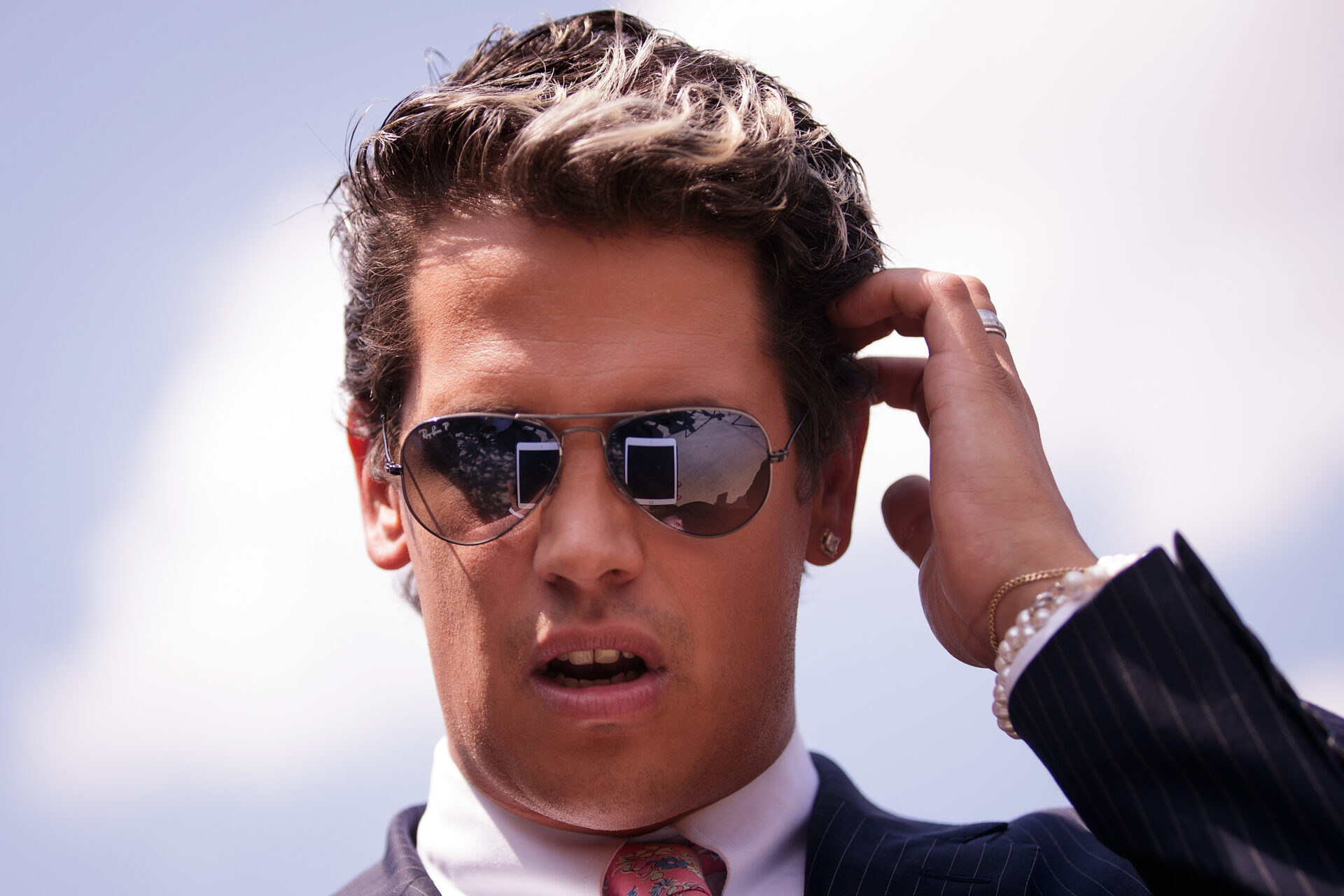 Milo Yiannopoulos looking at a tablet at a press conference near Pulse Nightclub in Orlando, Florida