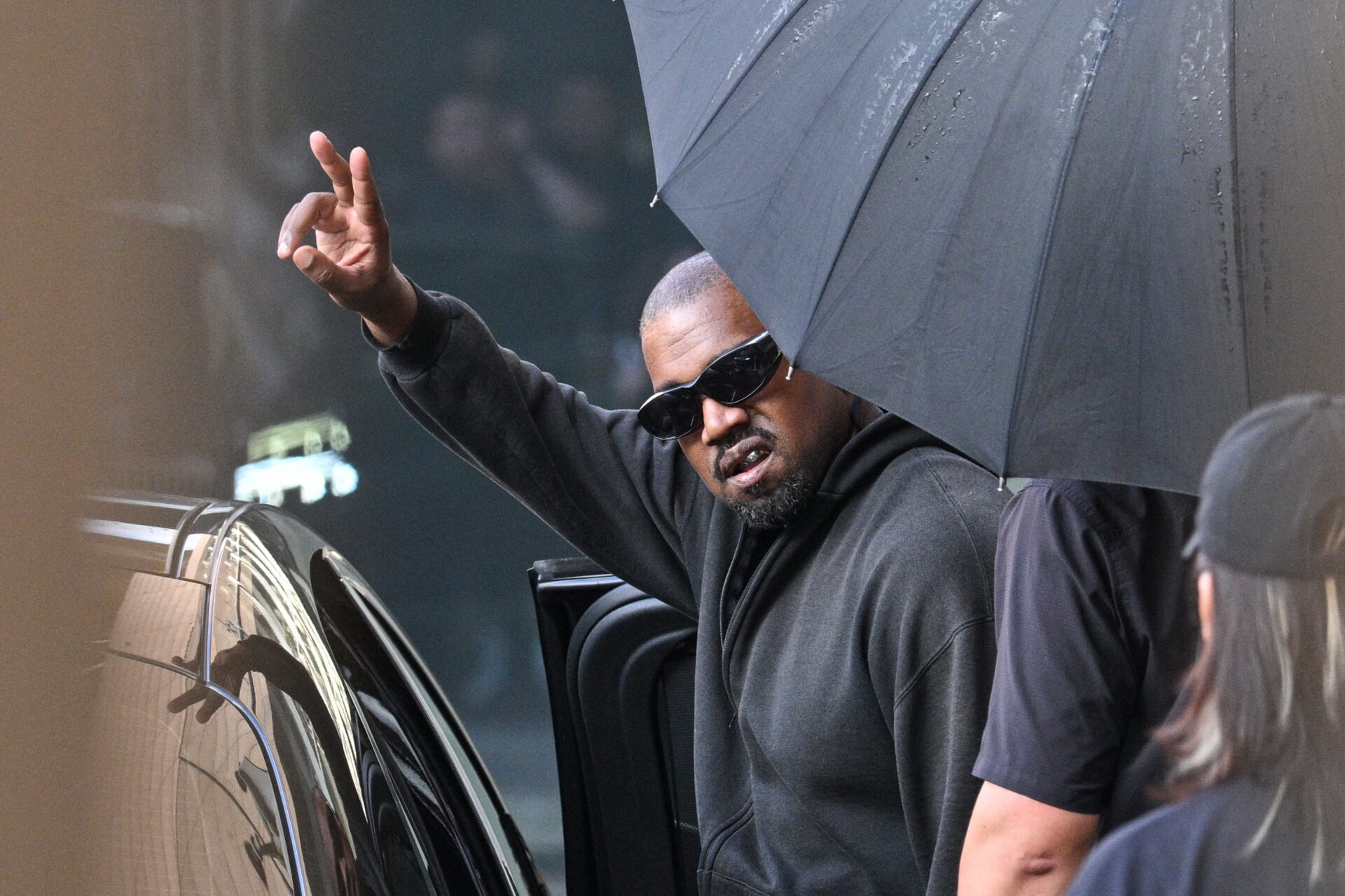 Kanye West gesturing upon arriving at Shanghai Pudong International Airport