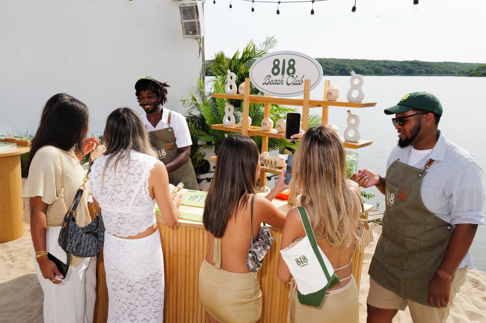 A group of guests line up at the 818 tequila bar at their event with The Surf Lodge