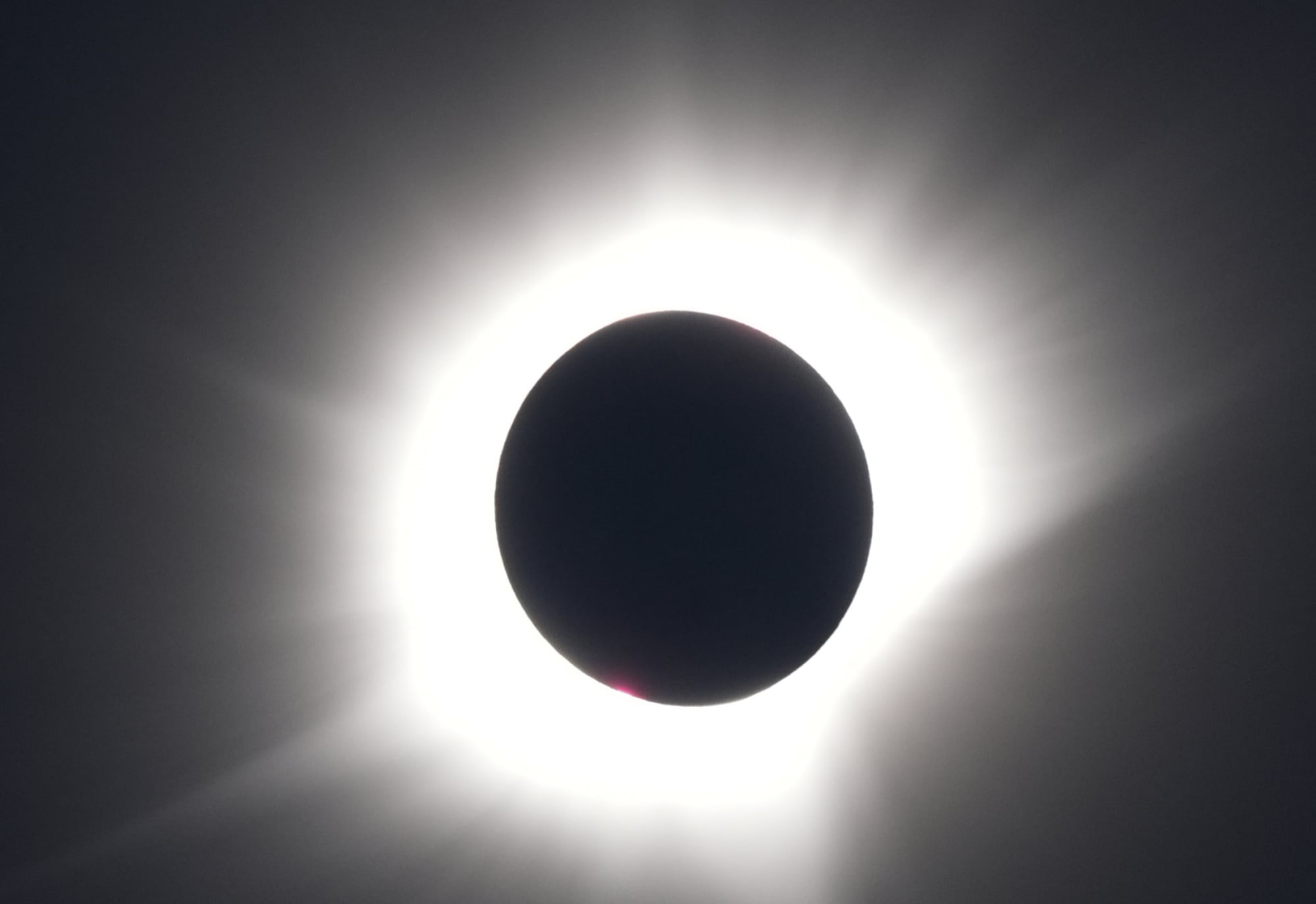 A black orb surrounded by glowing white light.