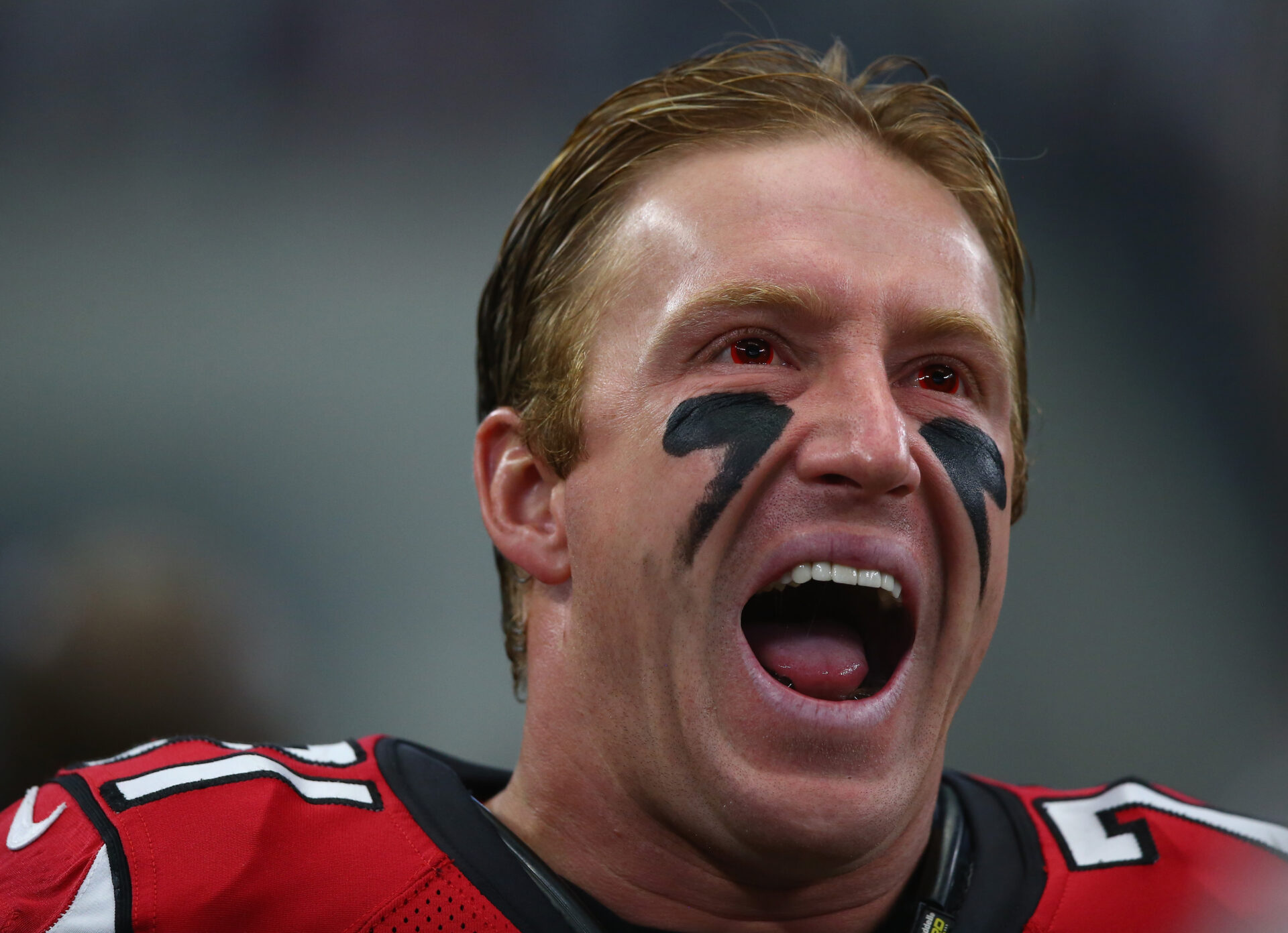 Kroy Biermann in his Atlanta Falcons uniform yelling on the sideline during a game against the Dallas Cowboys