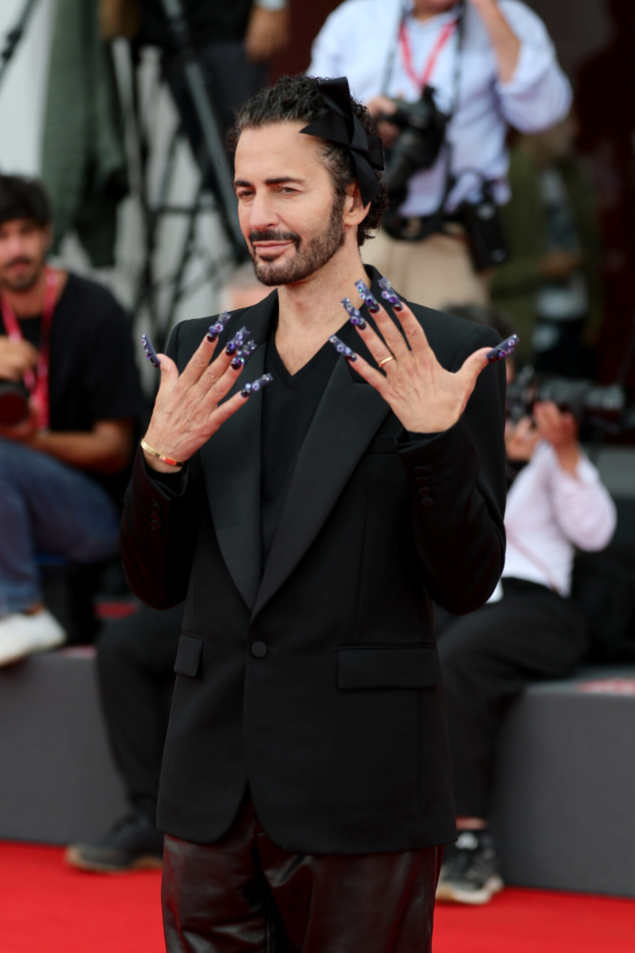 Marc Jacobs standing on a red carpet at the 82nd Venice International Film Festival