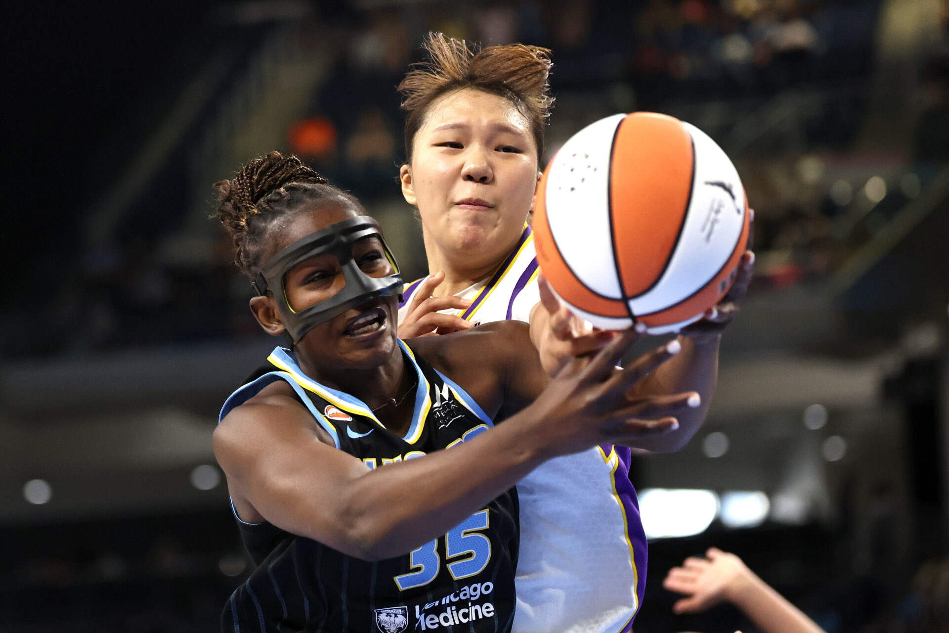 Aicha Coulibaly of the Chicago Sky and Jihyun Park of the Los Angeles Sparks competing on the court at Wintrust Arena