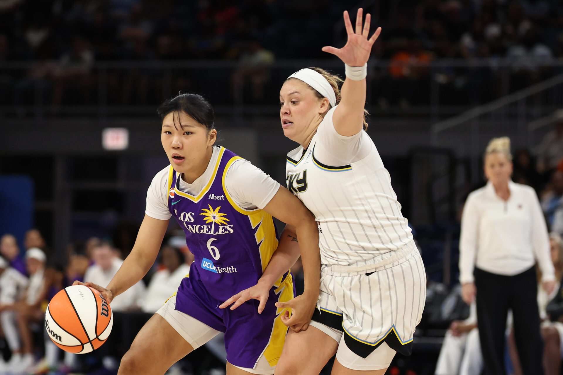 Jihyun Park of the LA Sparks dribbling past Rachel Banham of the Chicago Sky during a WNBA game at Wintrust Arena