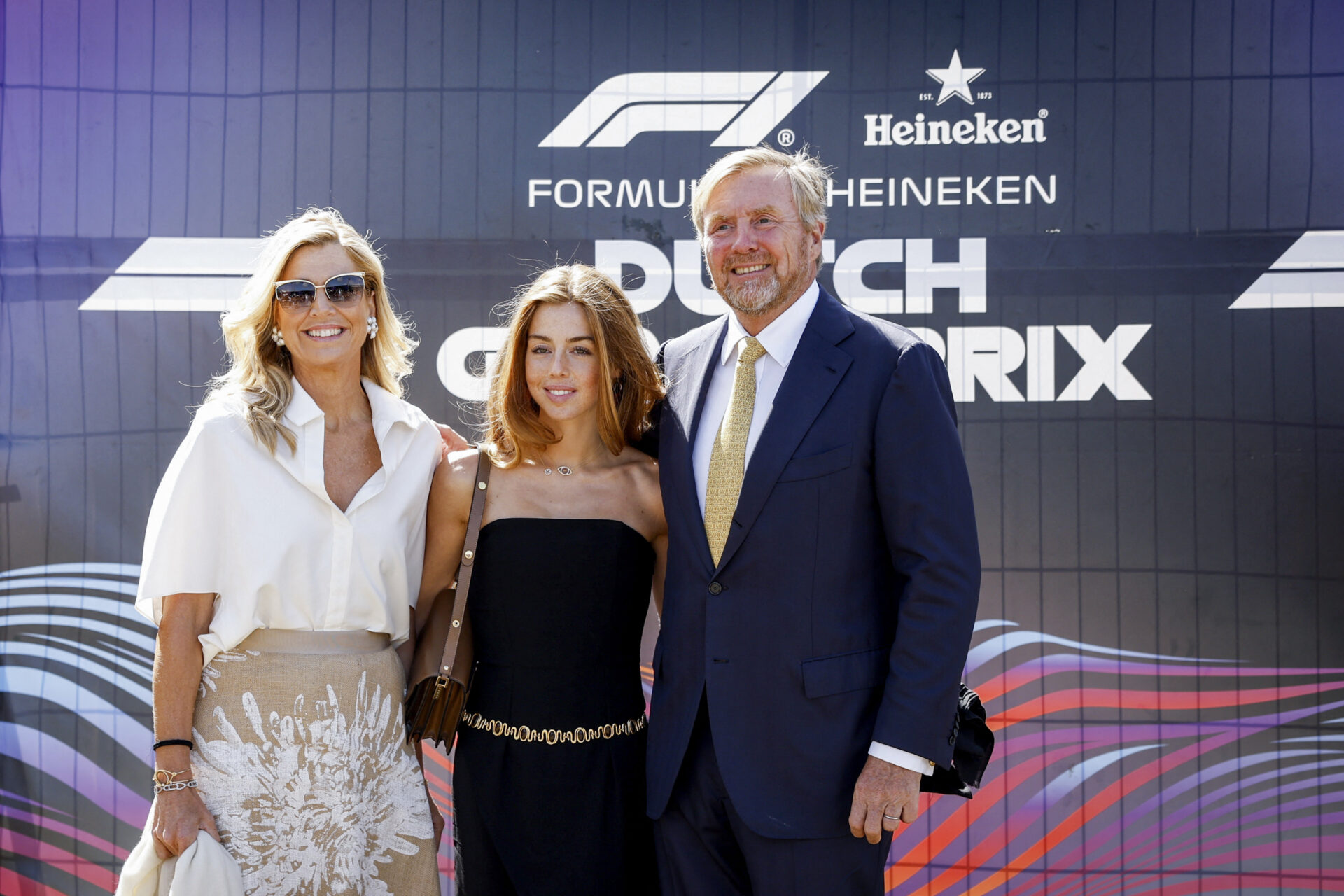 Princess Alexia Wore a Sleeveless Jumpsuit and a Gold Chain Belt to a Rain-Soaked Grand Prix