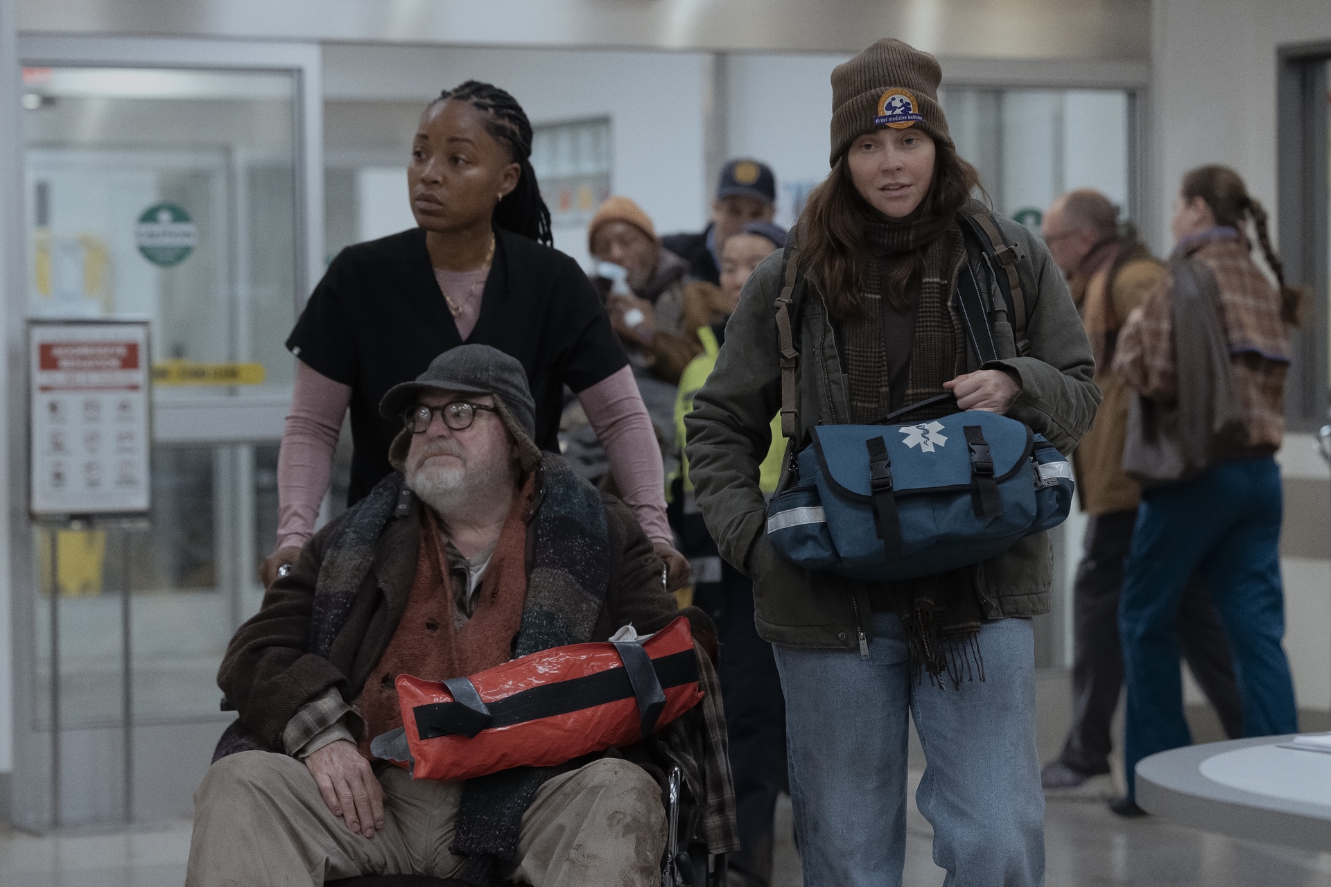 Actors on set in the central work area during filming of The Pitt Season 3