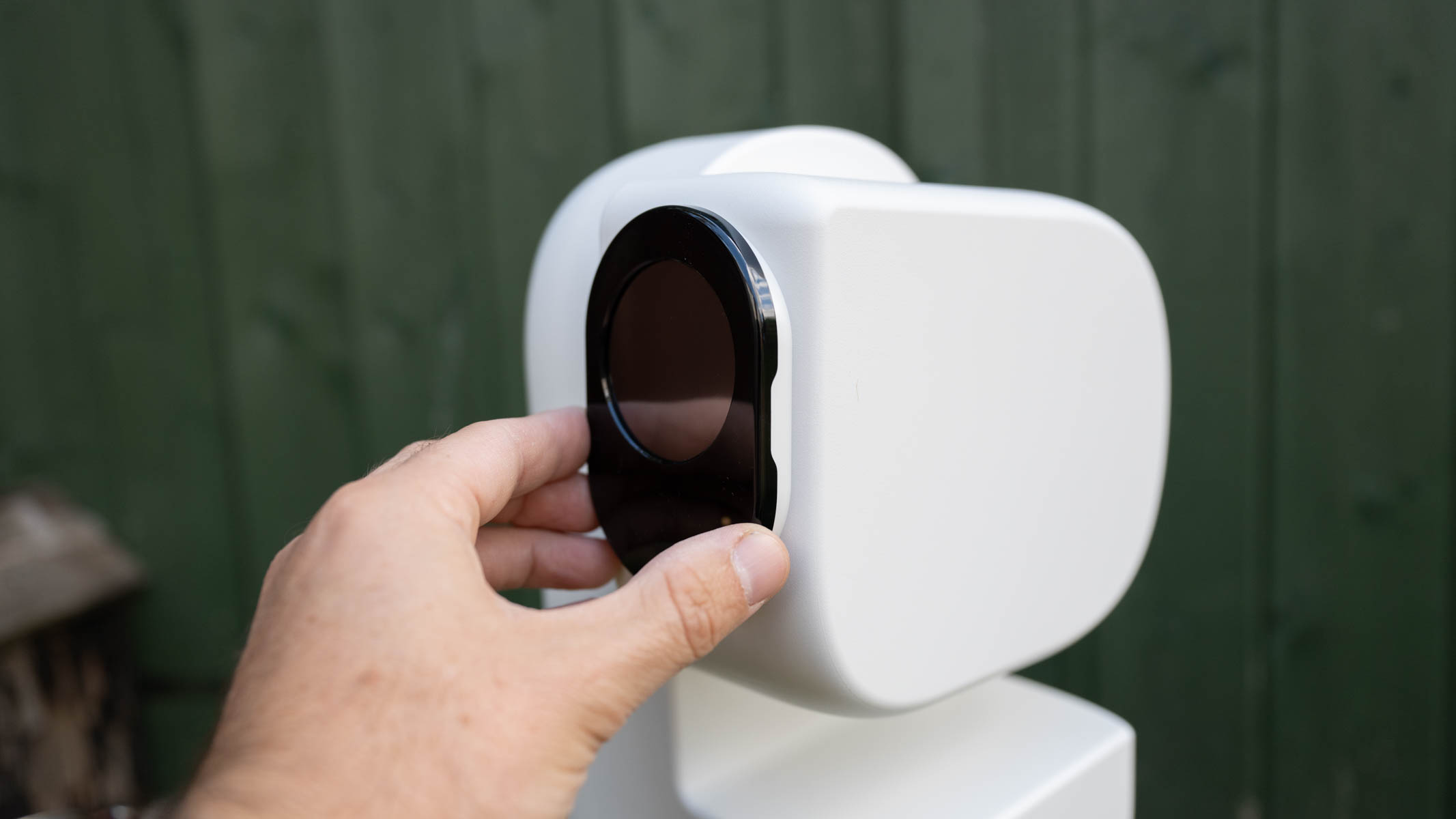 ZWO Seestar S50 Pro on a tripod against a green shed