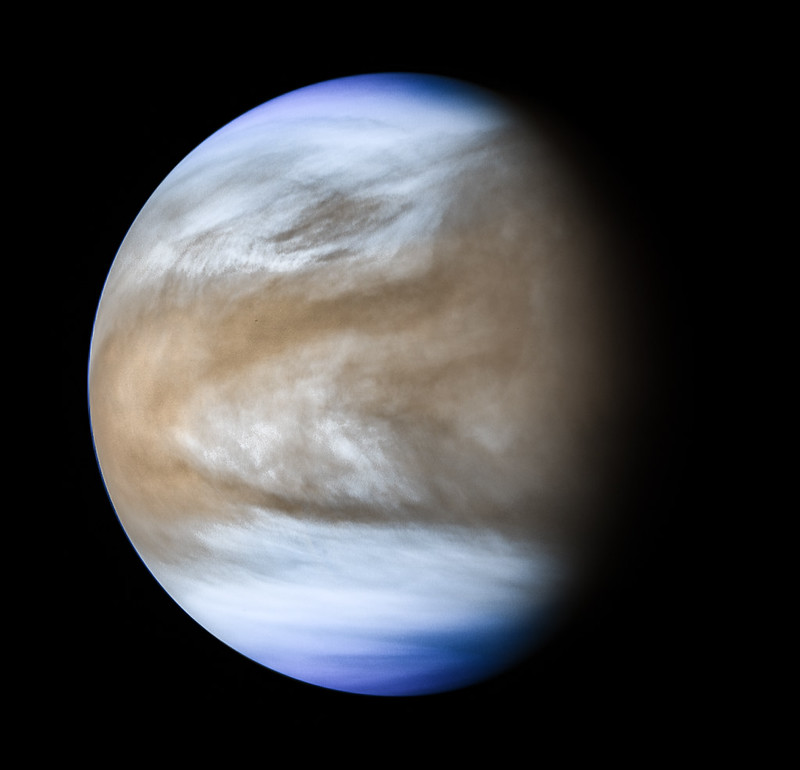 A blue and brown planet in deep space.