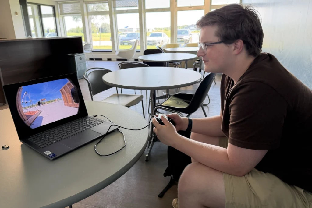 Reporter Alex Riehl remotely controlls an InDro robot.