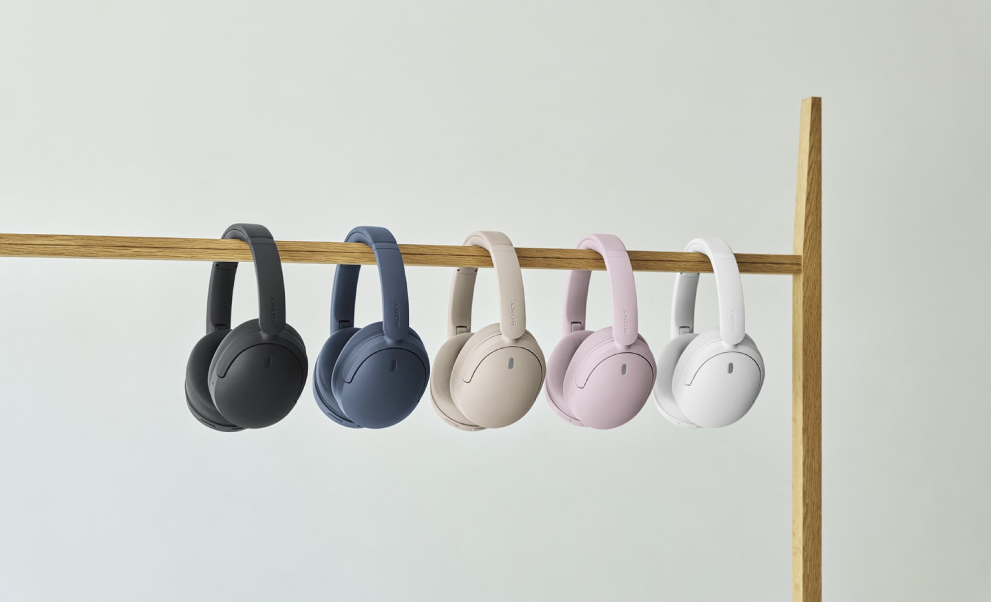 Sony WH-CH730N headphones hanging from a rod